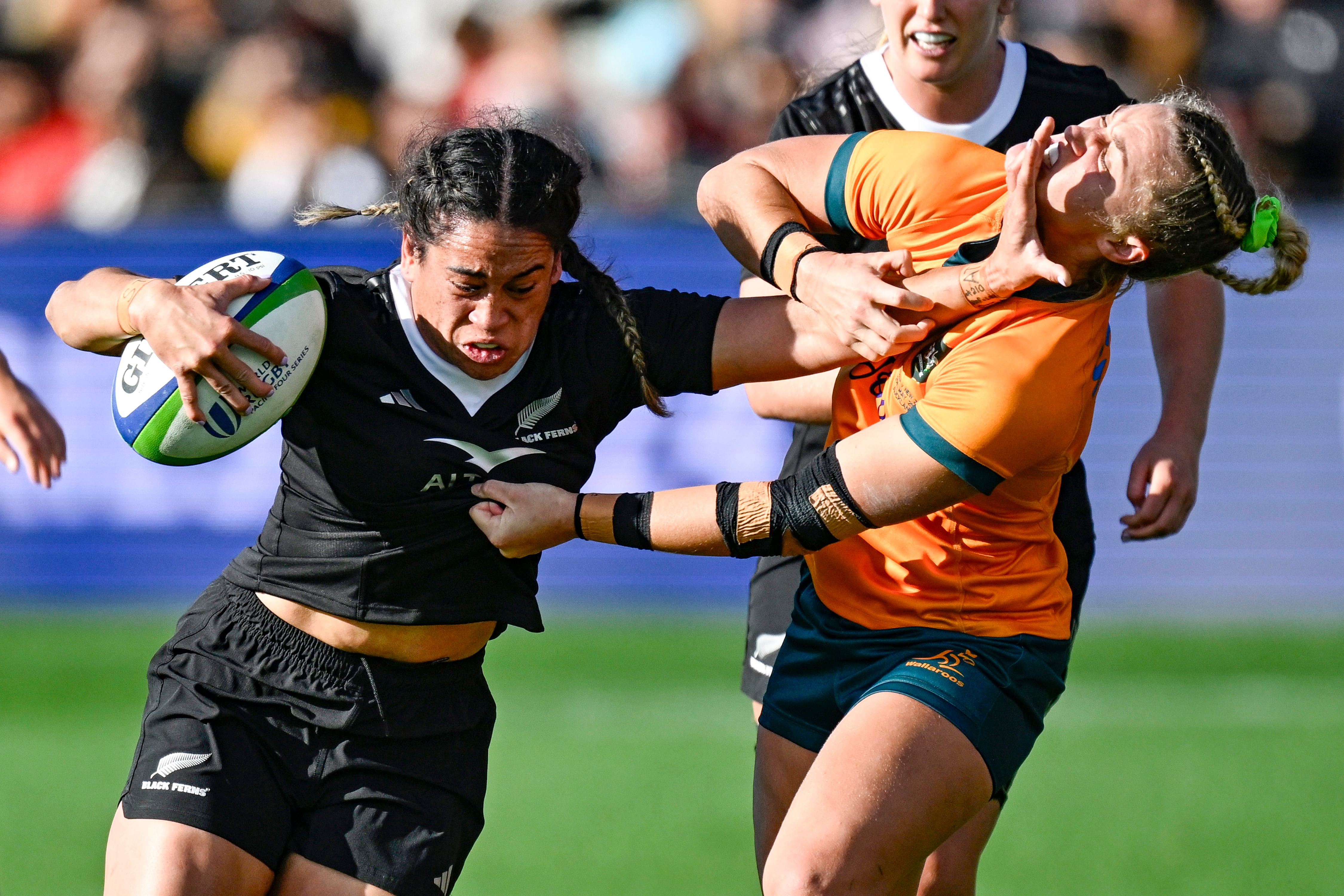 Black Ferns co-captain Kennedy Simon fends off Arabella McKenzie of Australia. Photo / Photosport