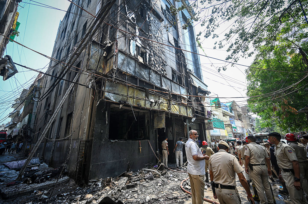 Firefighters and rescue personnel outside the five-storey Flourish Stay B&B, which was destroyed by fire. Photo / Hindustan Times via Getty Images