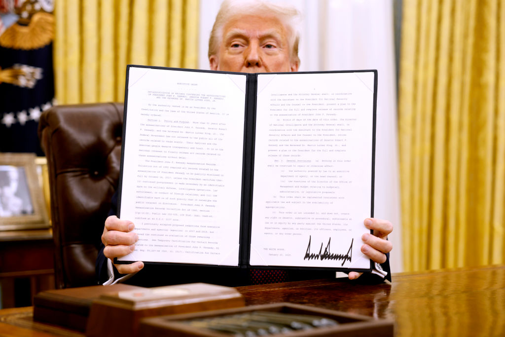 US President Donald Trump holds up a signed executive order in the Oval Office of the White House on January 23, 2025 in Washington, DC. Photo / Getty Images