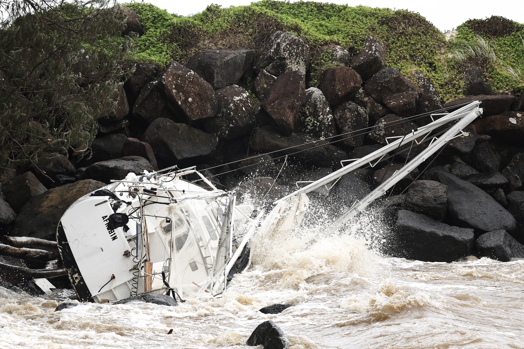 A damaged yacht swept away by the waves rests at Point Danger on the southern end of the Gold Coast on Friday. Violent winds toppled power lines on March 7 as Tropical Cyclone Alfred inched towards Australia's eastern coast, sparking evacuation orders and leaving more than 50,000 homes without electricity. Photo / AFP