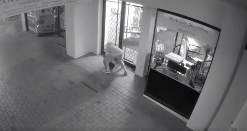 The man runs away from the store when the alarms are activated. 