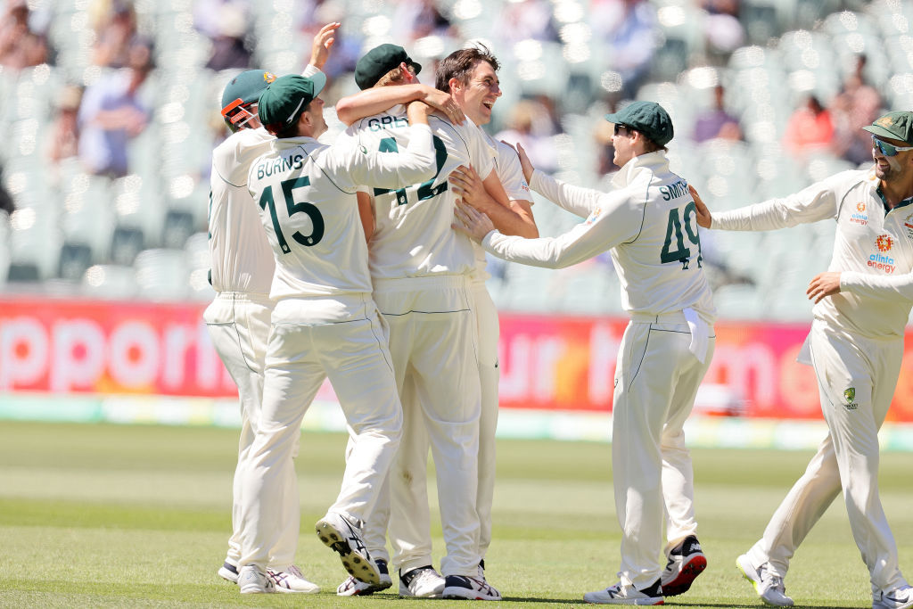 Pat Cummins celebrates with Cameron Green of Australia after taking a catch to dismiss Virat Kohli. Photo / Getty
