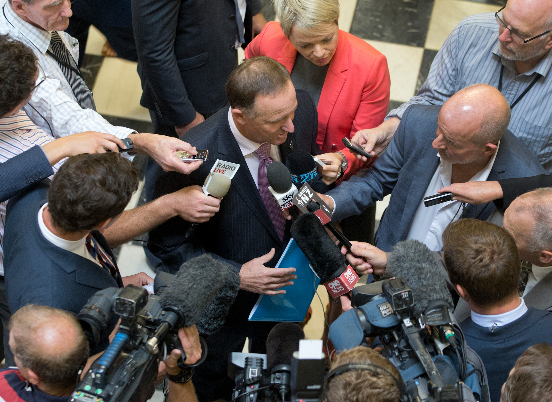 Former Prime Minister John Key faces questions on his way to the House in February 2015. Photo / Mark Mitchell