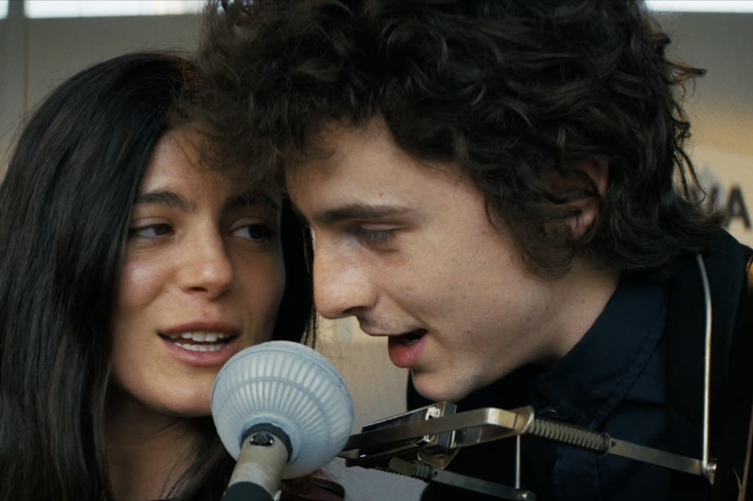 Timothée (pictured with Monica Barbaro who plays Joan Baez) wore a prosthetic nose for the biopic. Photo / Searchlight Pictures