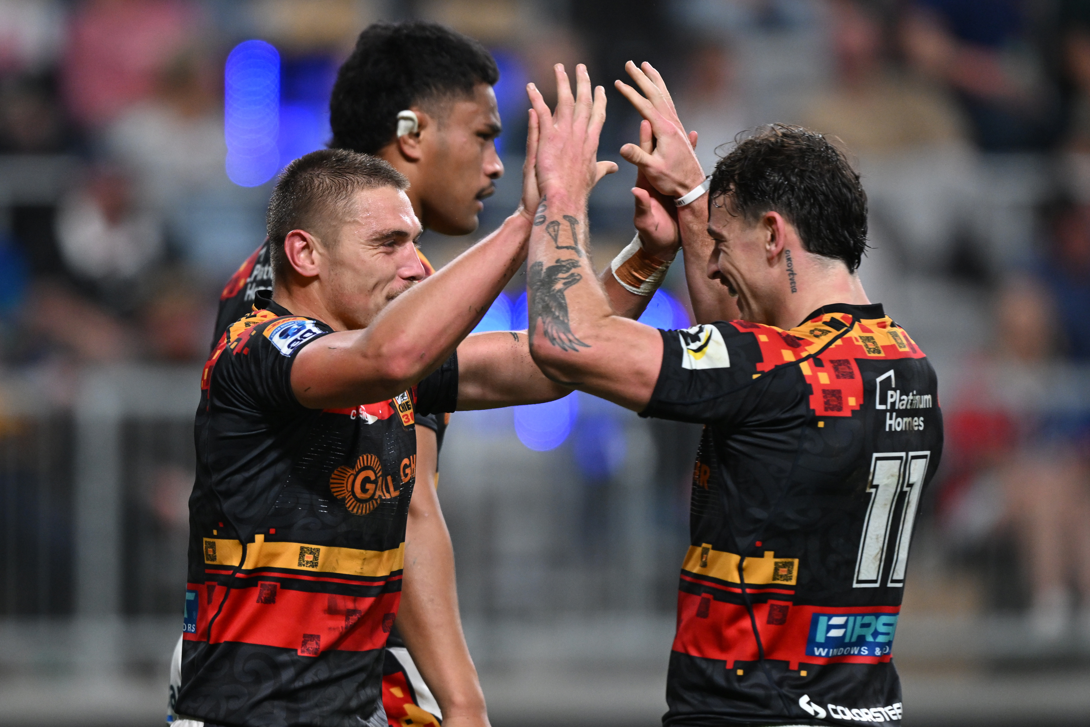 Cortez Ratima celebrates with Chiefs teammates after scoring against Fijian Drua. Photo / Photosport