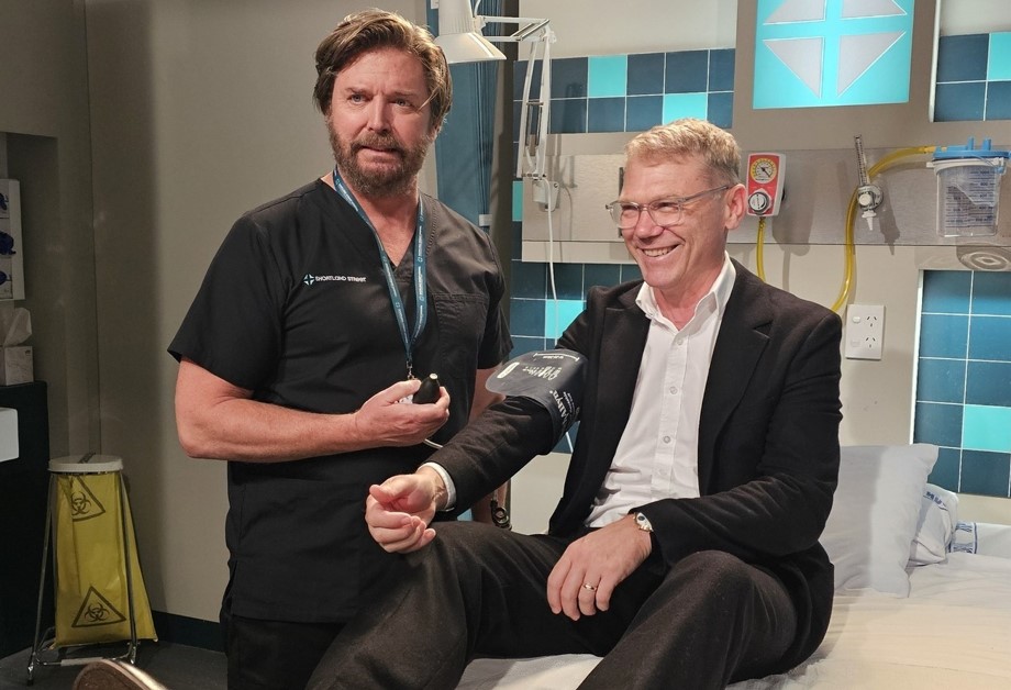 Shortland Street cast member Michael Galvin (Dr Chris Warner, left) checks Government minister Paul Goldsmith's blood pressure.