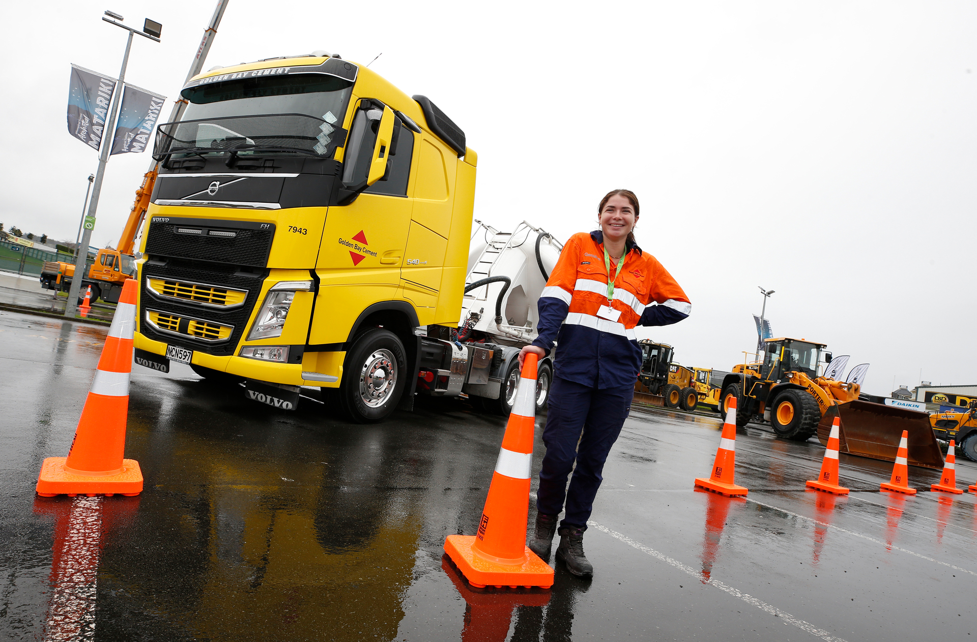 Ciara O'halloran stands next to a Golden Bay Cement truck at the Girls in Infrastructure Event at Semenoff Stadium, Whangārei. Photo / Michael Cunningham