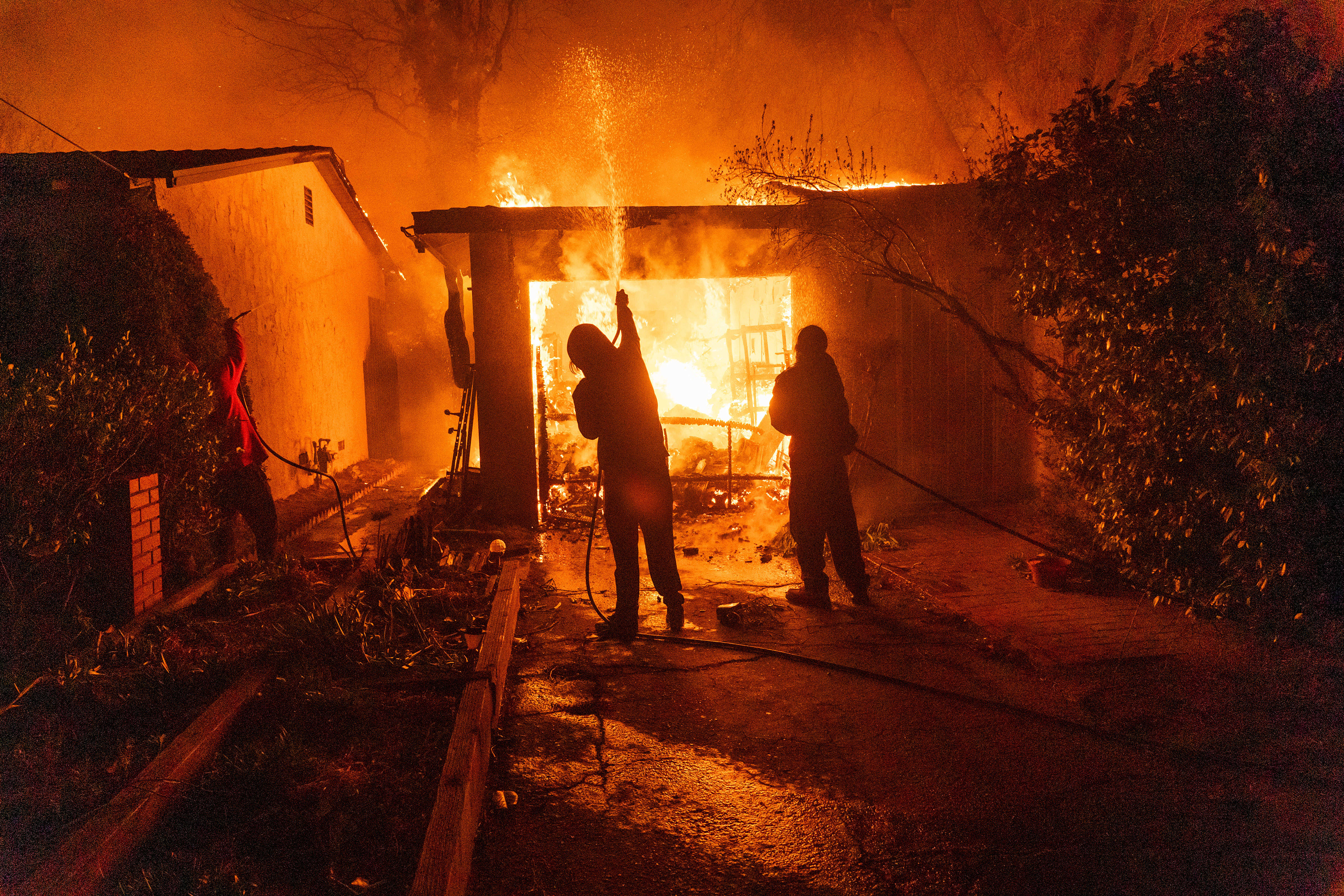 Residents battle a fire in Altadena, LA County on January 8. Photo / Kyle Grillot, The New York Times