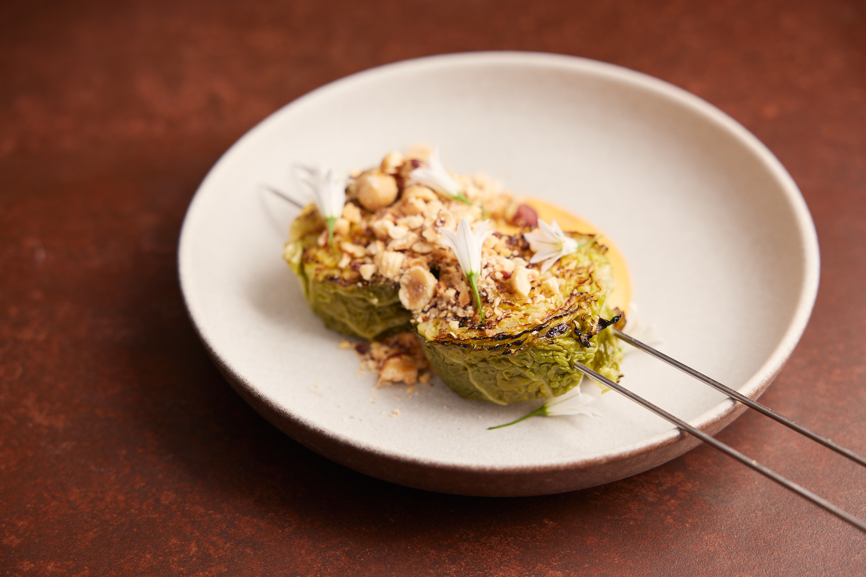 Grilled cabbage, smoked tomato and hazelnuts from the opening week menu at Sid and Chand Sarawat's newest Auckland restaurant Kol. Photo / Josh Griggs