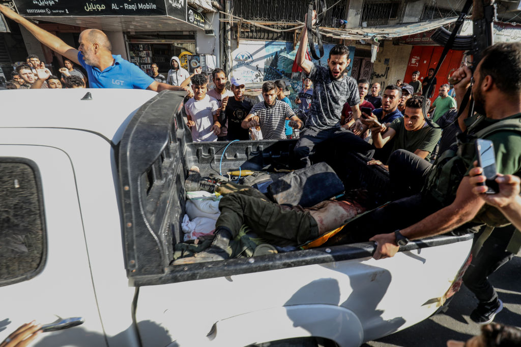 Palestinian militants surround a truck reportedly carrying a captured Israeli after crossing the border fence with Israel from Khan Yunis. Photo / Getty Images