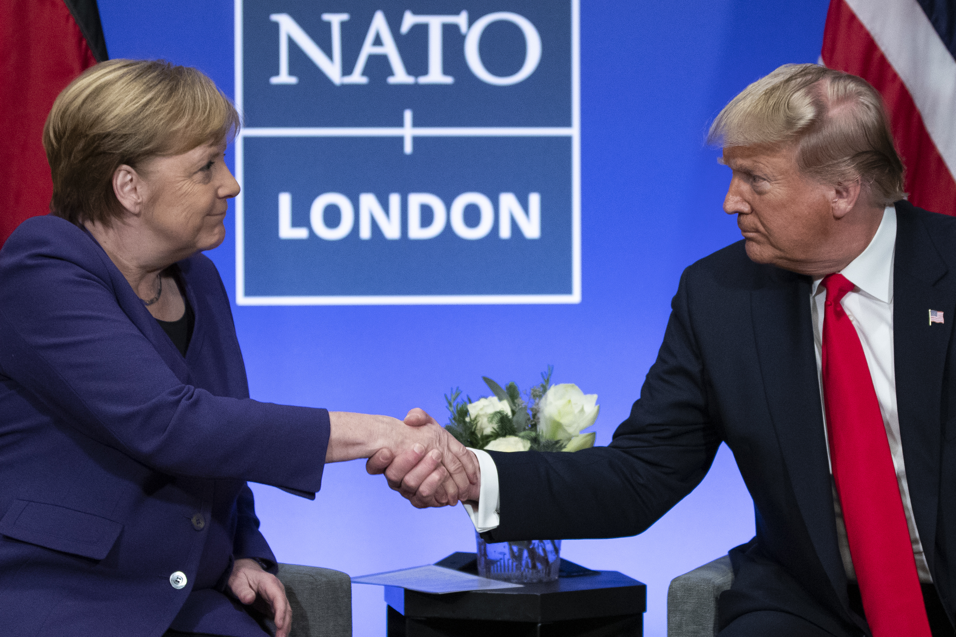 Then-US President Donald Trump with then-German Chancellor Angela Merkel during a Nato summit. Photo / AP
