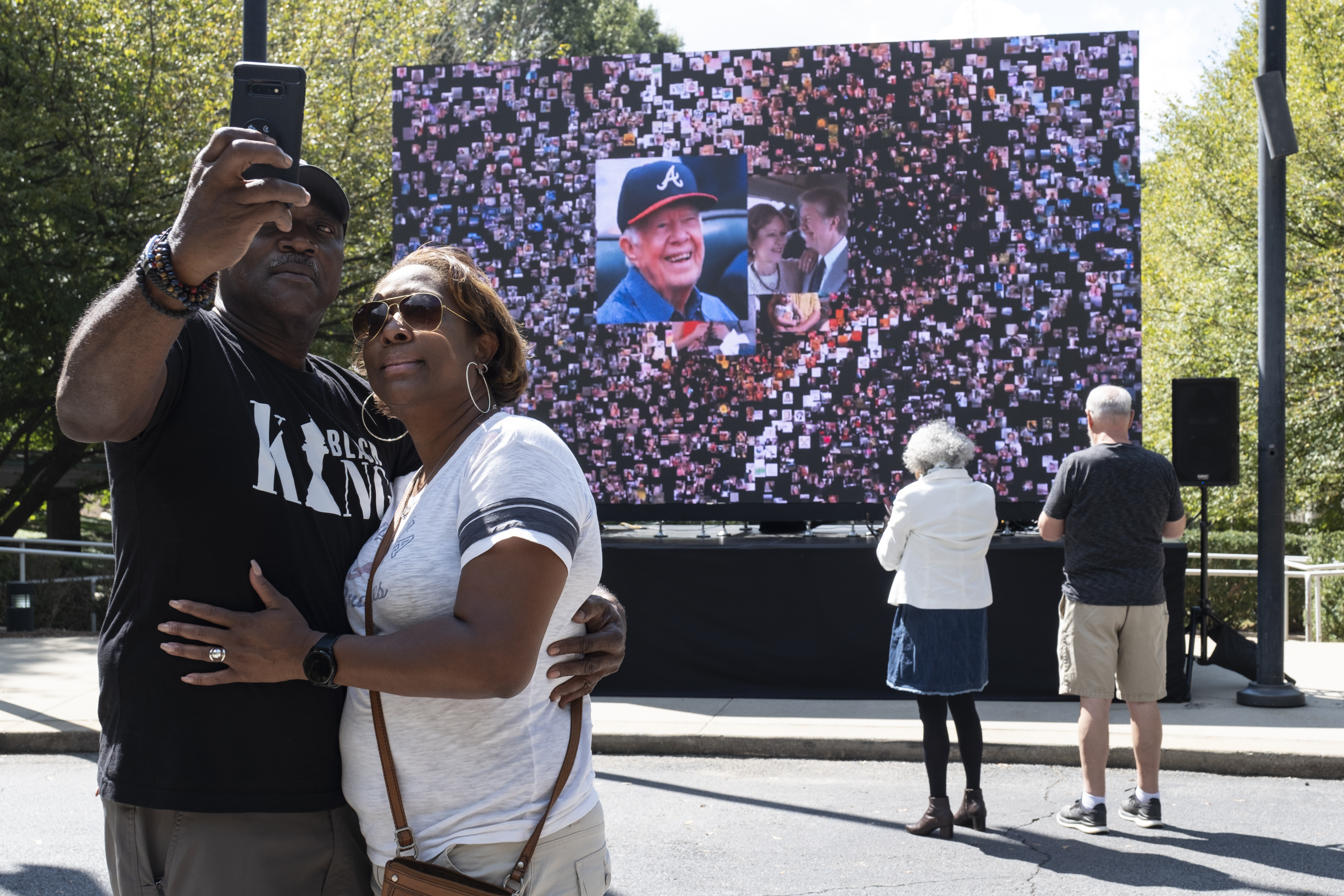 Kevin and Ursula Jones take a photo together in front of a video screen while attending the celebration for President Jimmy Carter's 99th birthday, held at The Carter Centre in Atlanta. Photo / AP