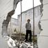 Brad Molan, 13, surveys the damage to the old squash court at St Stephen's School. Photo / Steven McNicholl