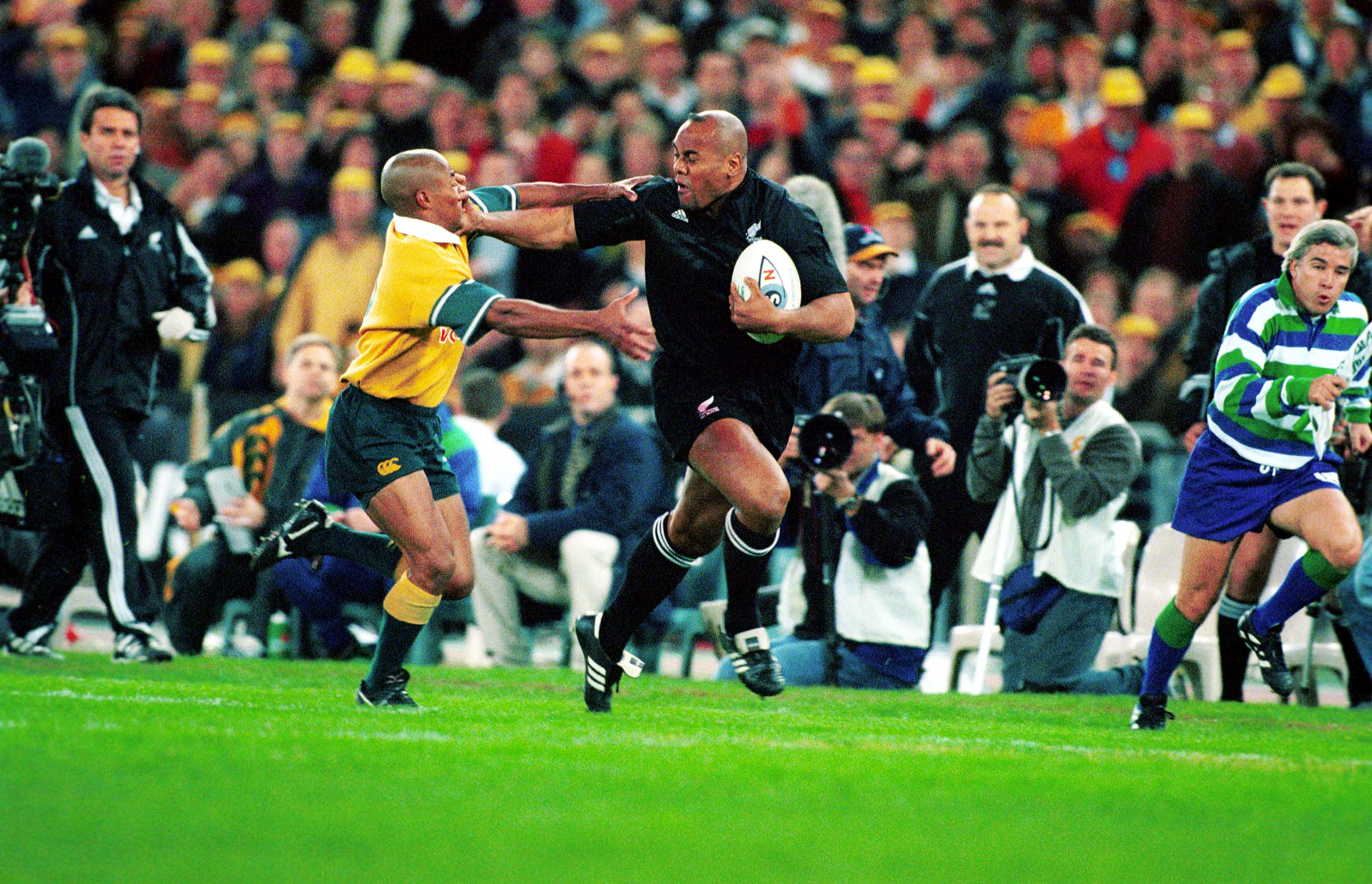 Jonah Lomu fends off George Gregan in a Bledilsoe Cup clash in 2000. Photo / Photosport