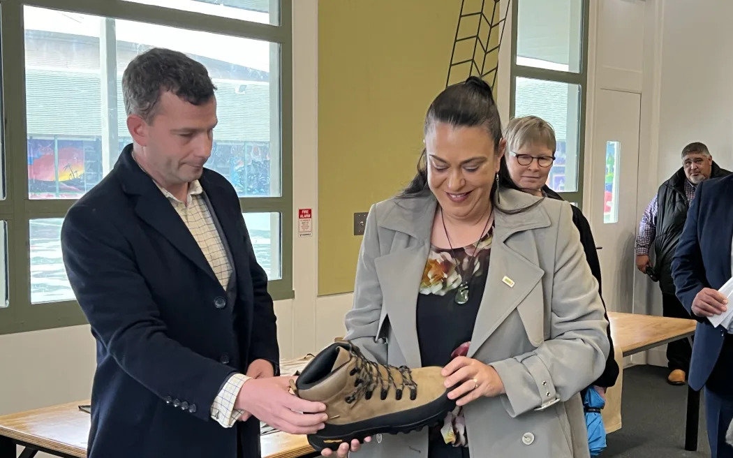 Act leader David Seymour and Minister for Children Karen Chhour look at the type of footwear youth at the new military academy pilot will receive. Photo / Rachel Helyer-Donaldson, RNZ