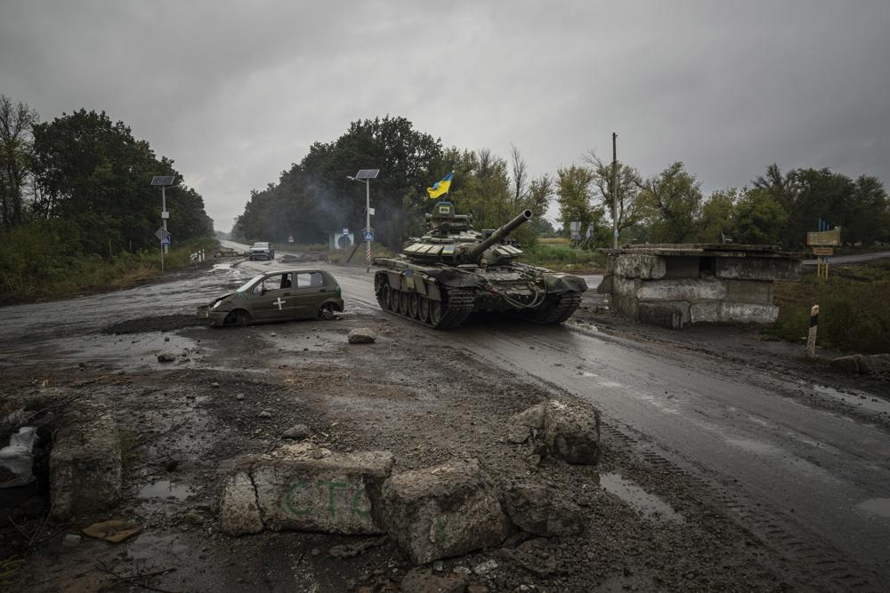 A Ukrainian tank drives past a former Russian checkpoint in the recently retaken area of Izium, Ukraine. Photo / AP