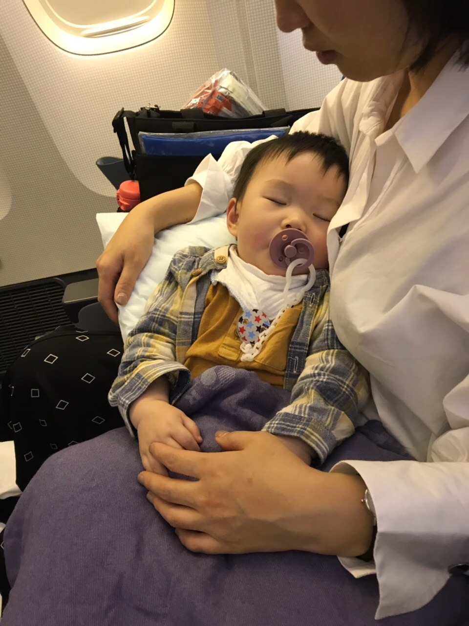 Bassinet fell off plane wall with baby inside injuring mother on Korean Air flight NZ Herald