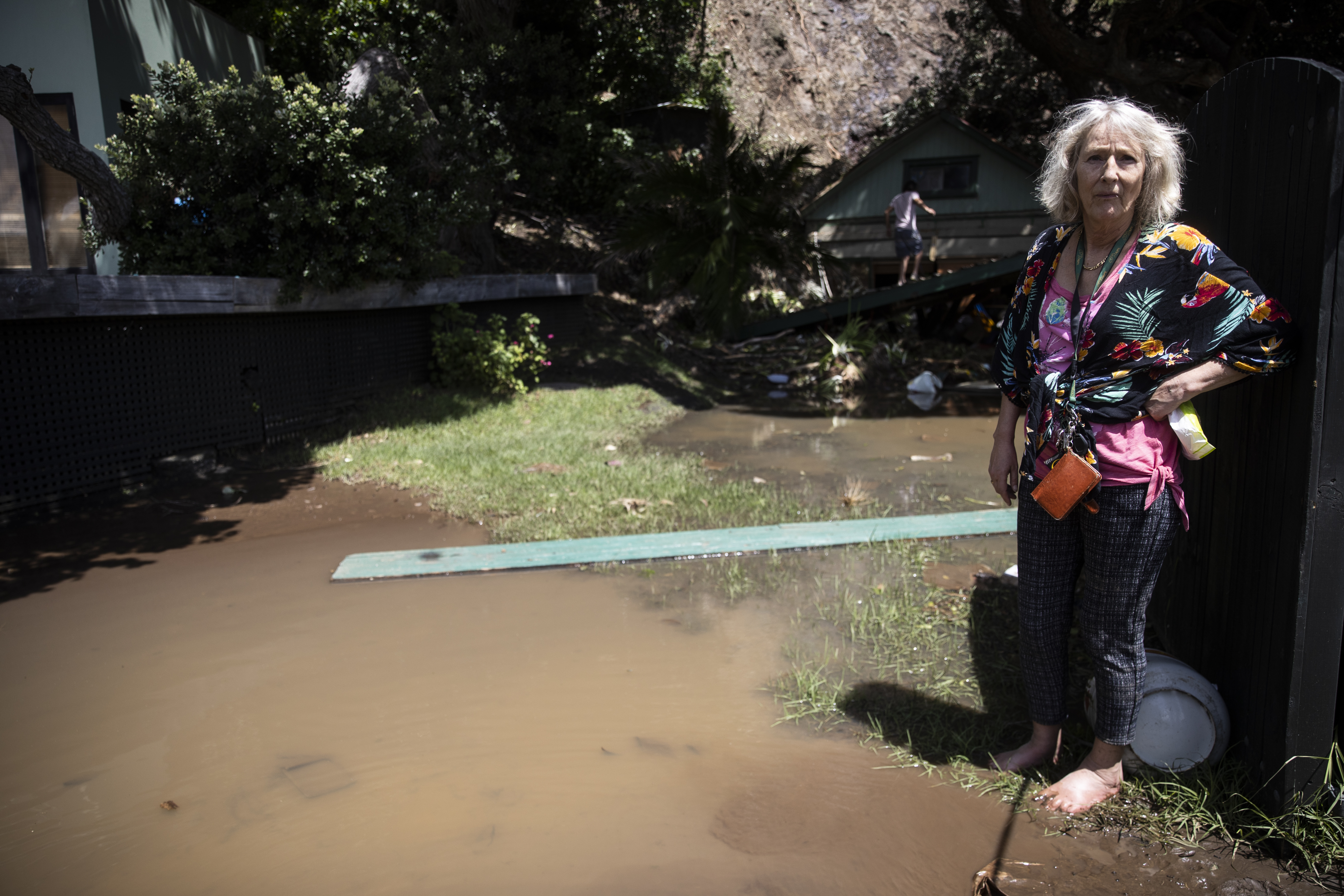 Vicki Pomeroy surveys her damaged Piha property. Photo / George Heard