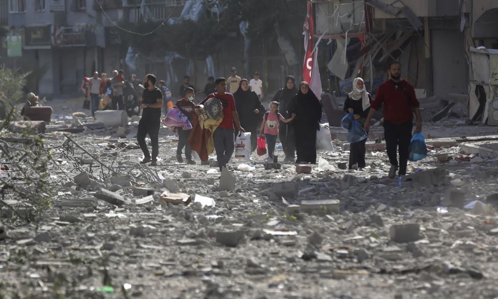 Palestinians leave their homes following Israeli bombardment of Gaza City. Photo / AP