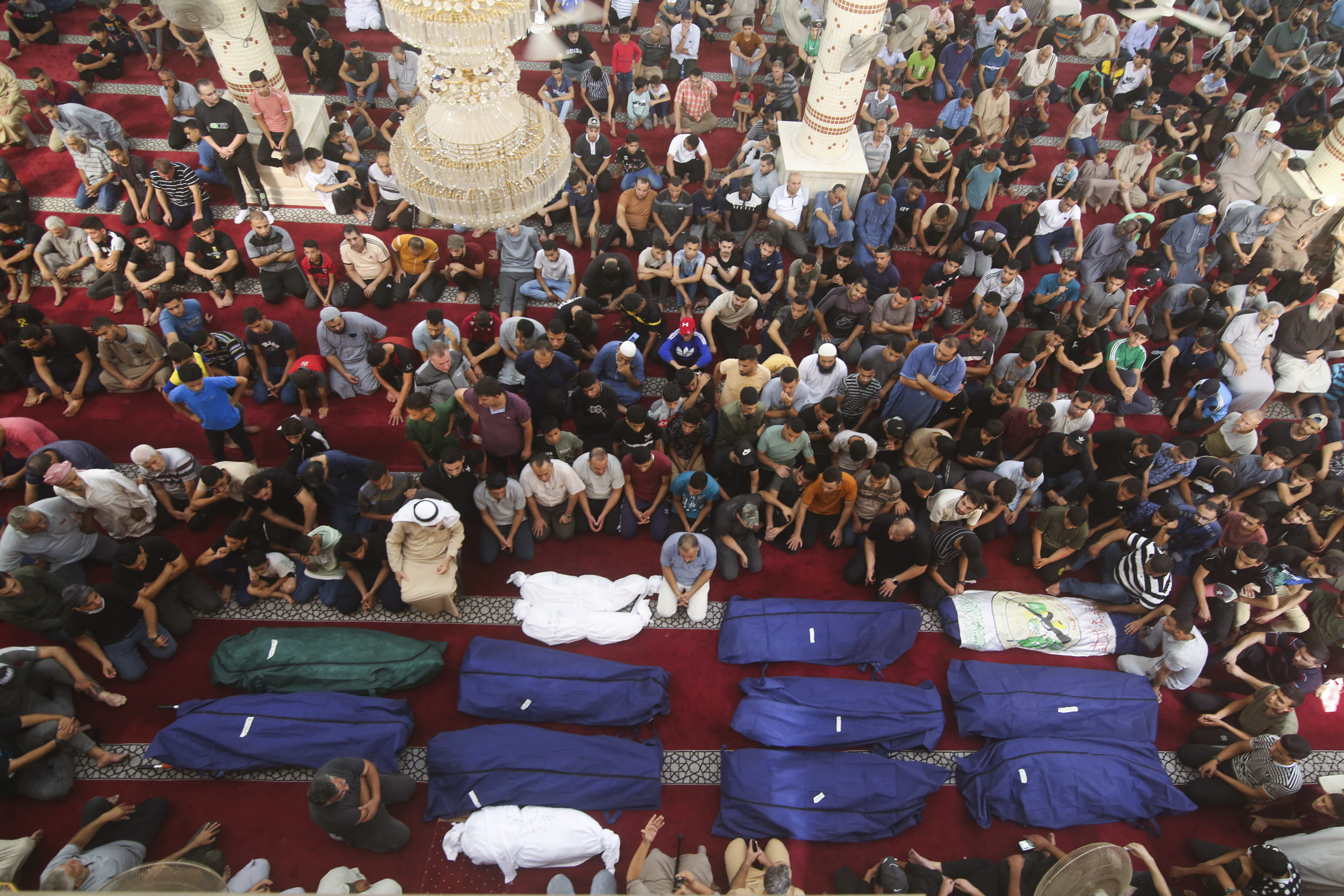 Mourners pray by the bodies of Salem Abu Quta family members, a Hamas fighter, during a funeral after they were killed in an Israeli strike on their house in Rafah refugee camp, southern Gaza Strip. Photo / AP