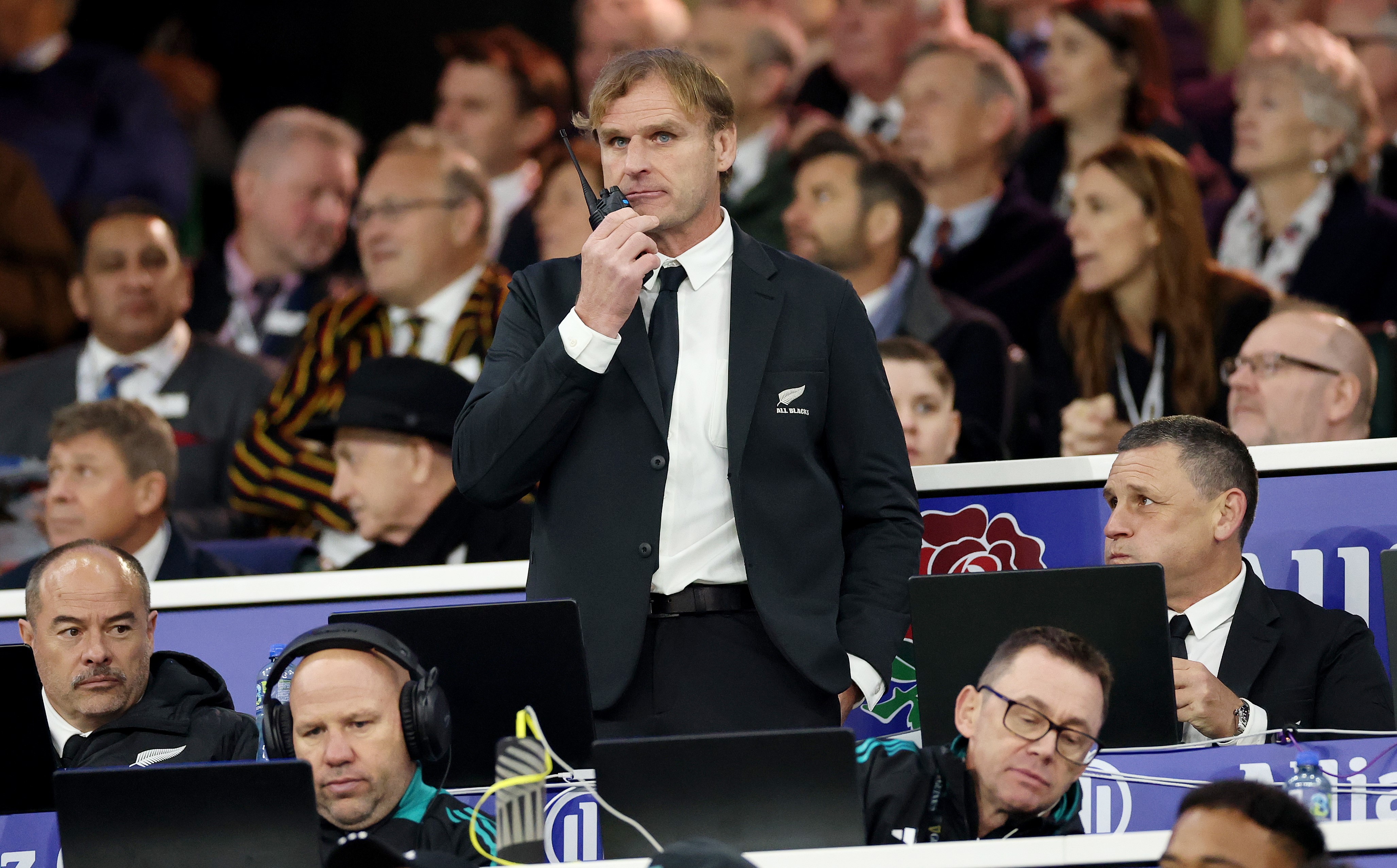 All Blacks head coach Scott Robertson makes a call at Twickenham alongside assistants, from left, Scott Hansen and Jason Ryan, and, far right, Jason Holland.