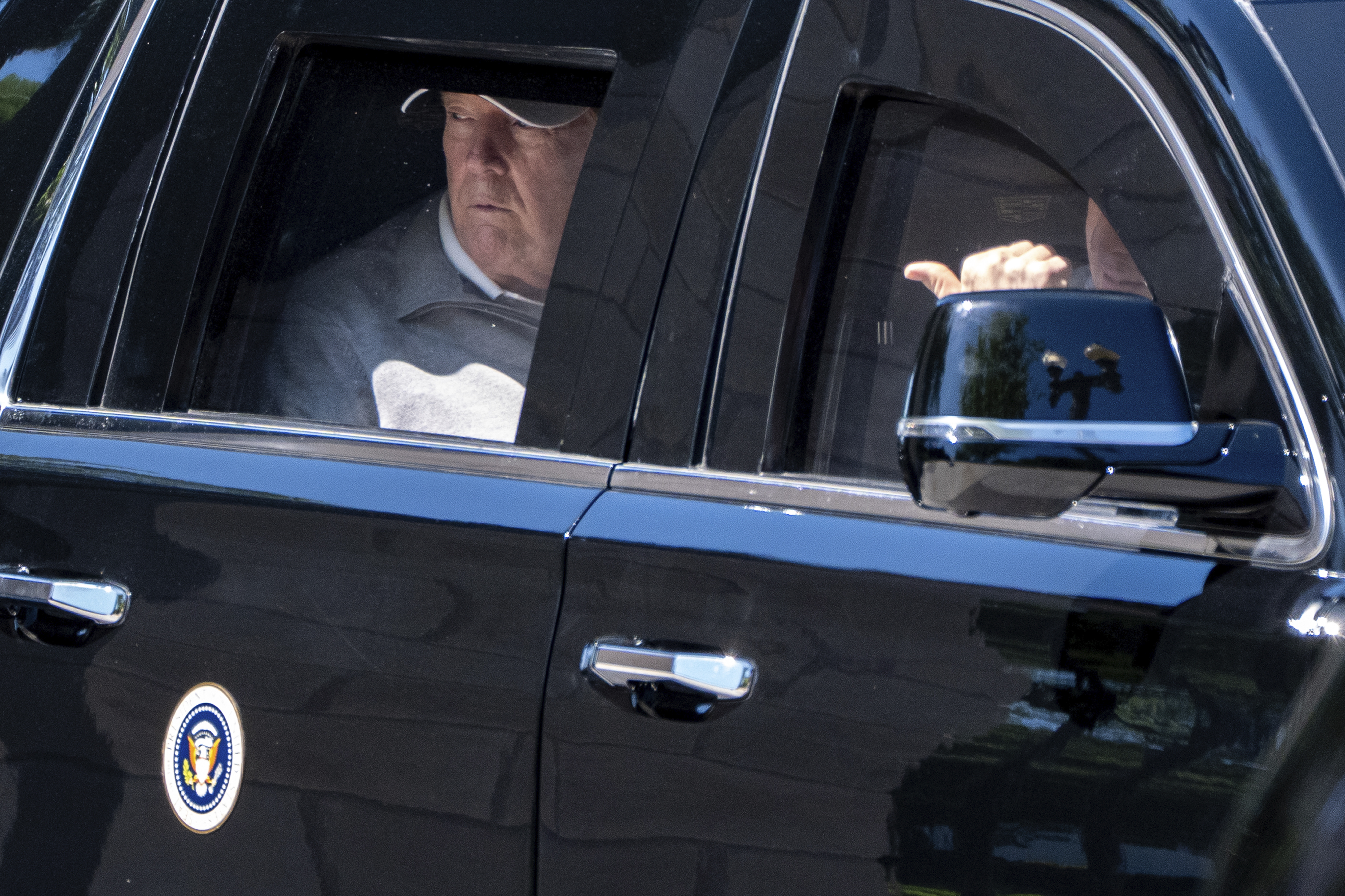 President Donald Trump looks out the window of his limousine at the construction in Lafayette Park as he departs the White House, Saturday, May 30, 2026, in Washington.