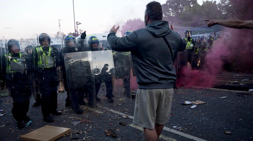 In this image taken from PA Video, police and protestors clash during a protest following the death of Henry Nowak, a 18-year-old student stabbed to death with a Sikh kirpan ceremonial by Vickrum Digwa, in Southampton