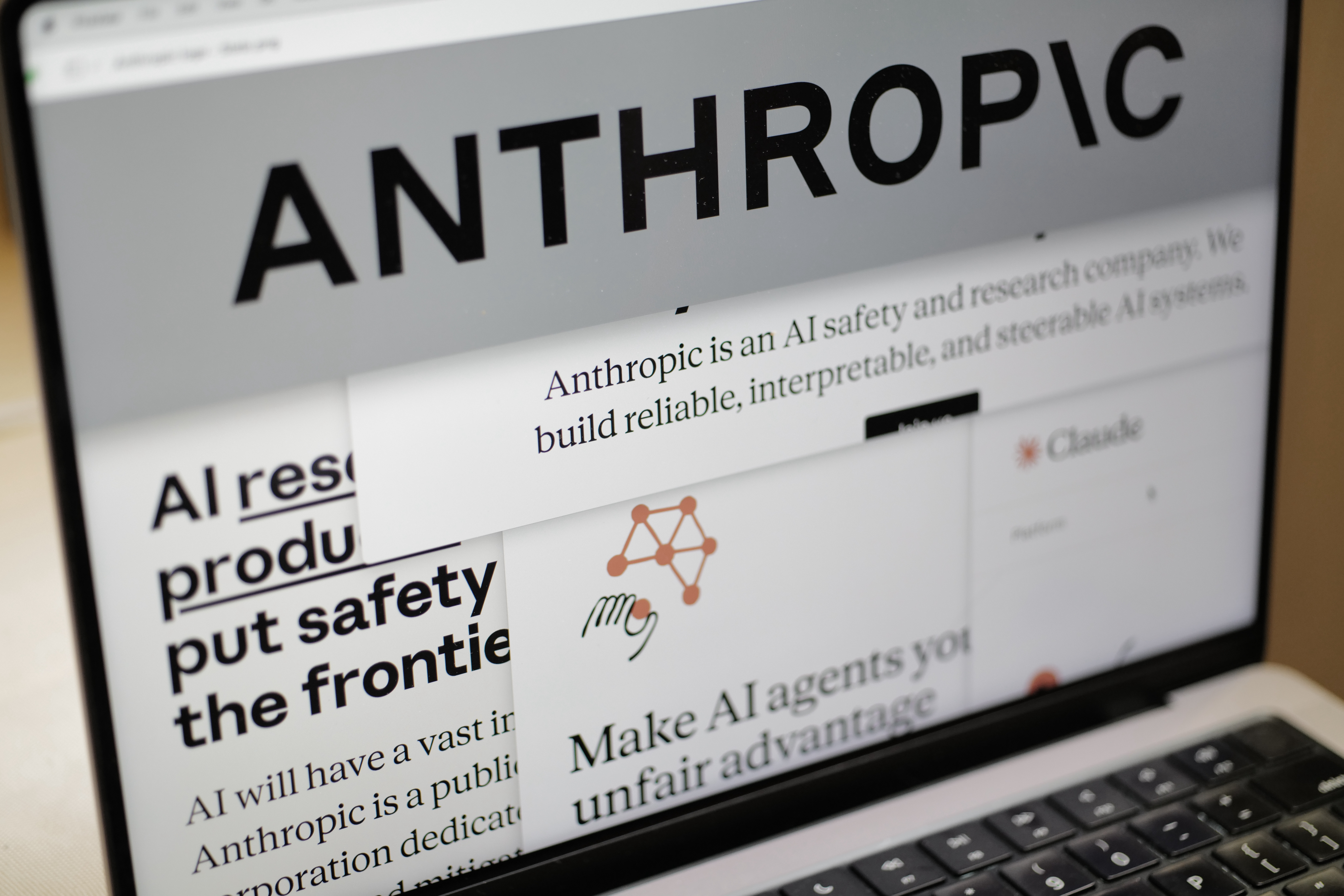 Pages from the Anthropic website and the company's logo are displayed on a computer screen in New York on Thursday, Feb. 26