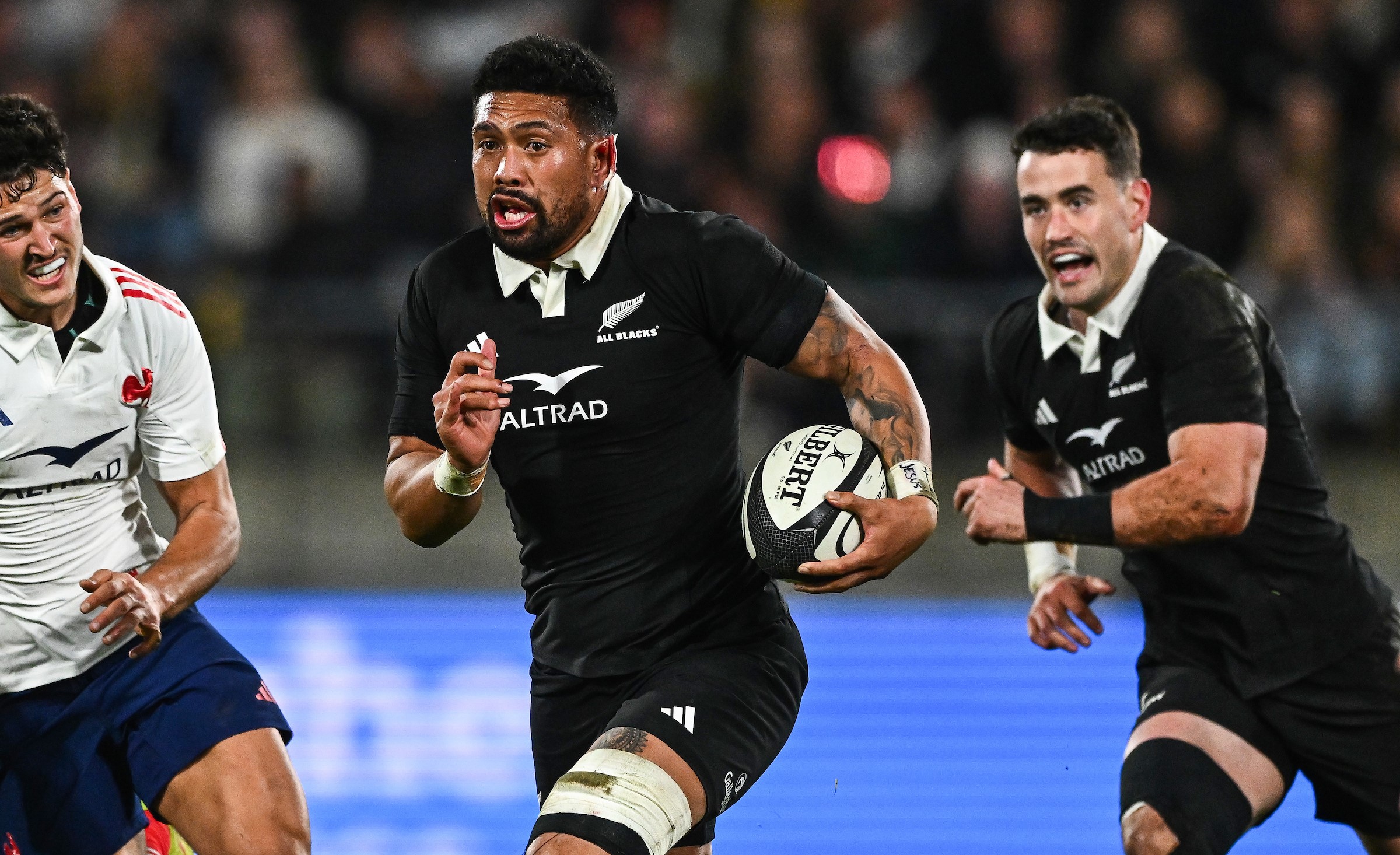 Ardie Savea makes a break against France, with Will Jordan in support.