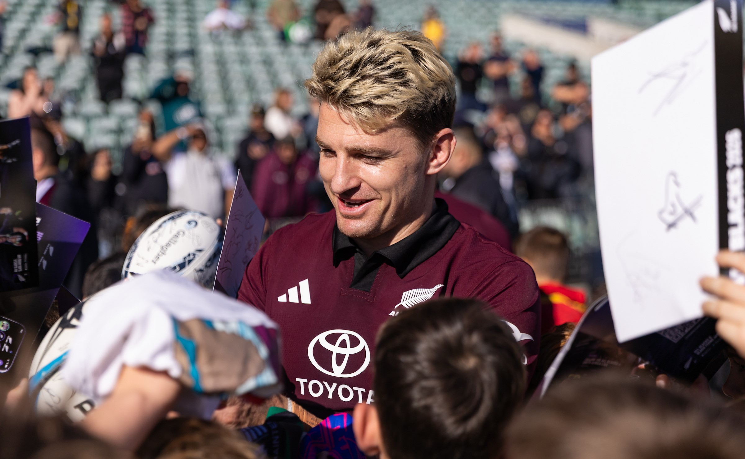All Blacks first-five Beauden Barrett signs autographs after training at North Harbour Stadium yesterday.