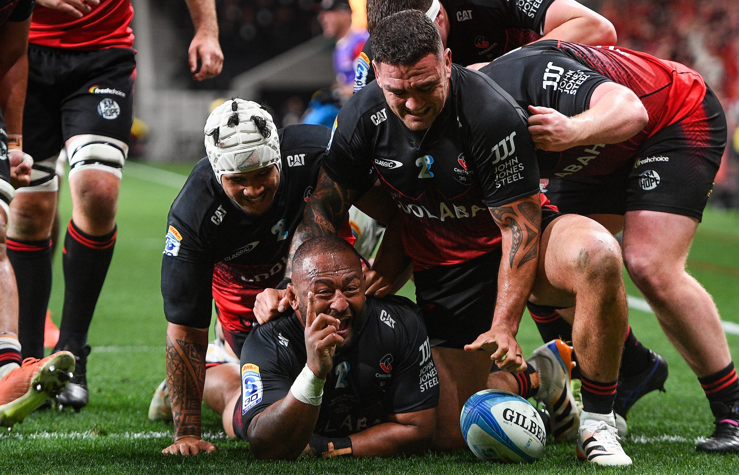 George Bower celebrates his try for the Crusaders against the Blues.