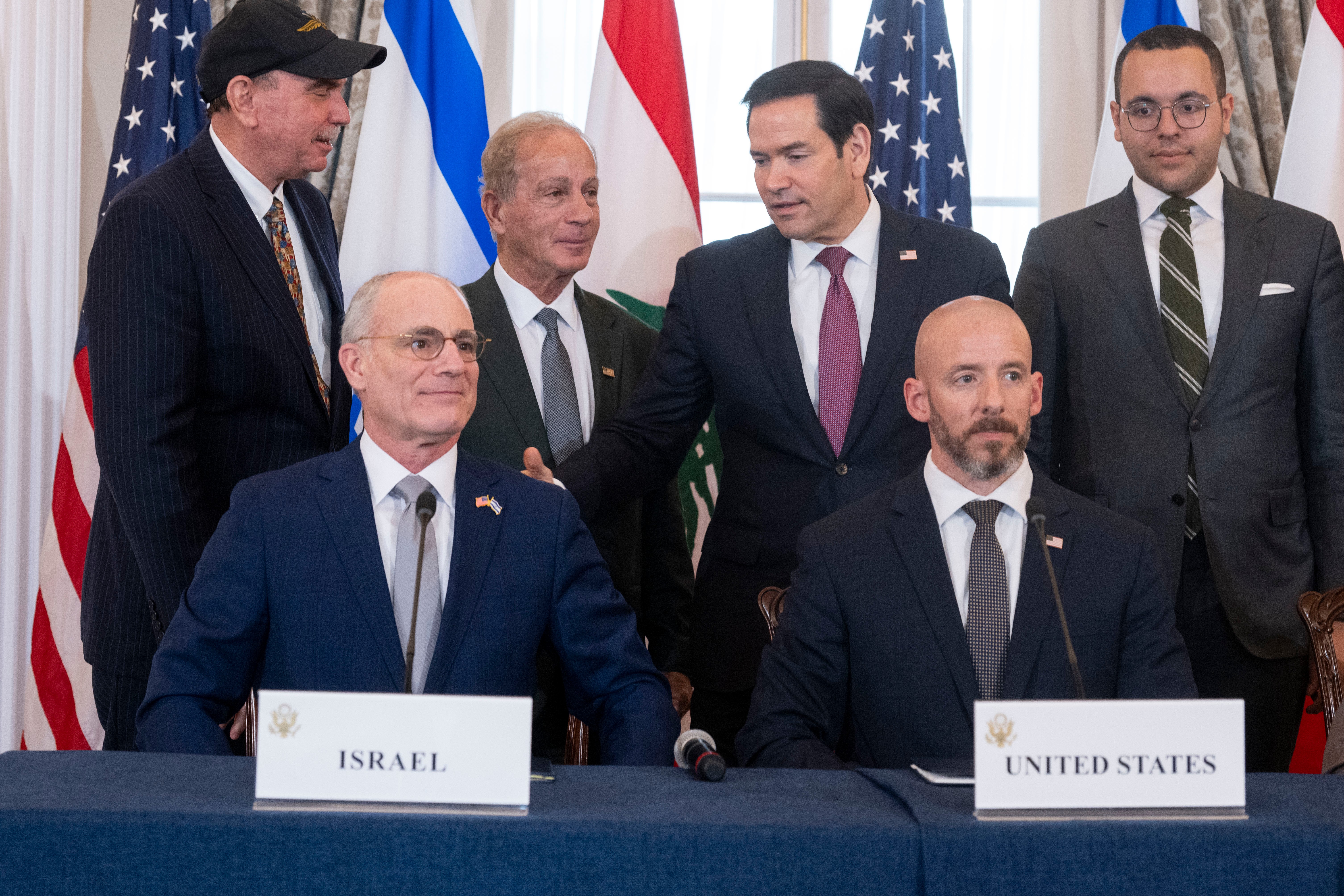 Secretary of State Marco Rubio pats Israel's Ambassador to the US Yechiel Leiter, lower left, on the back, following a signing of a framework agreement, described as a first step toward peace. 