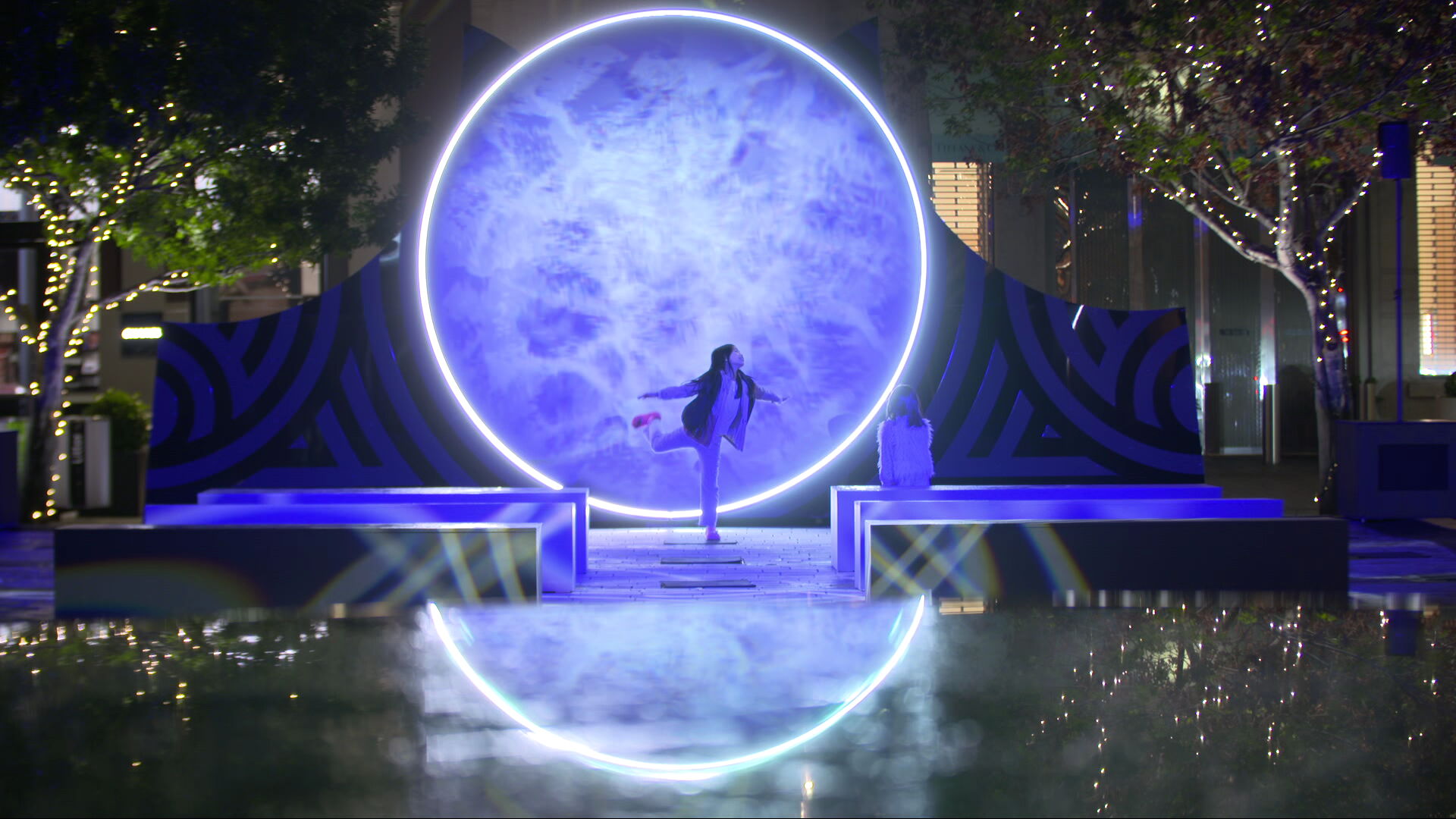 Child dances in front of a Matariki ki te Manawa installation at Takutai Square, Auckland CBD.