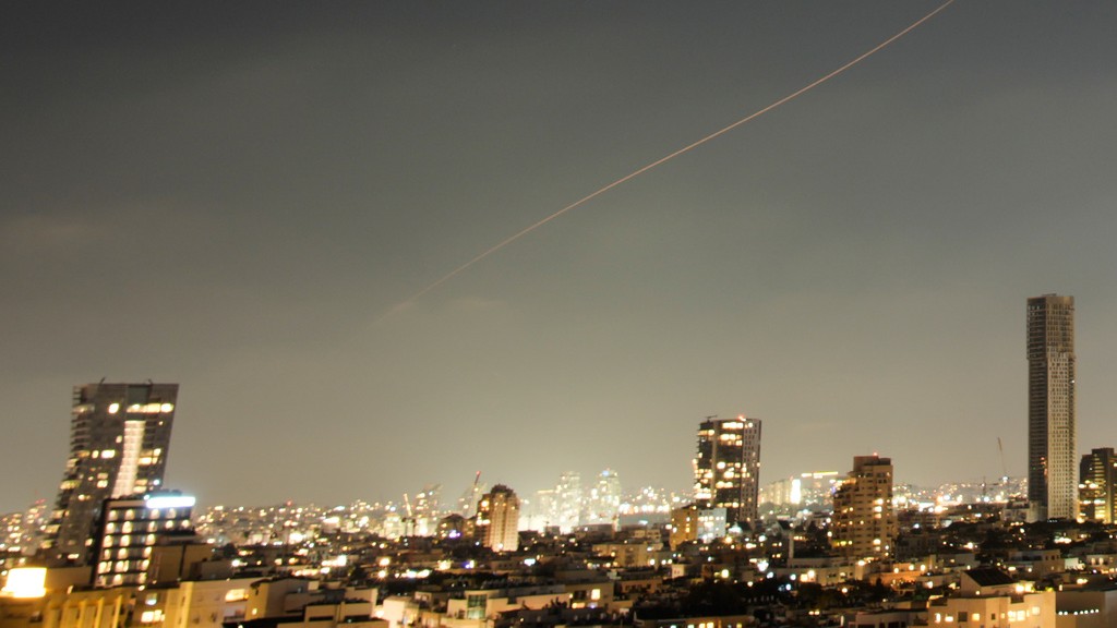A projectile streaks through the sky over central Israel during an Iranian missile attack.