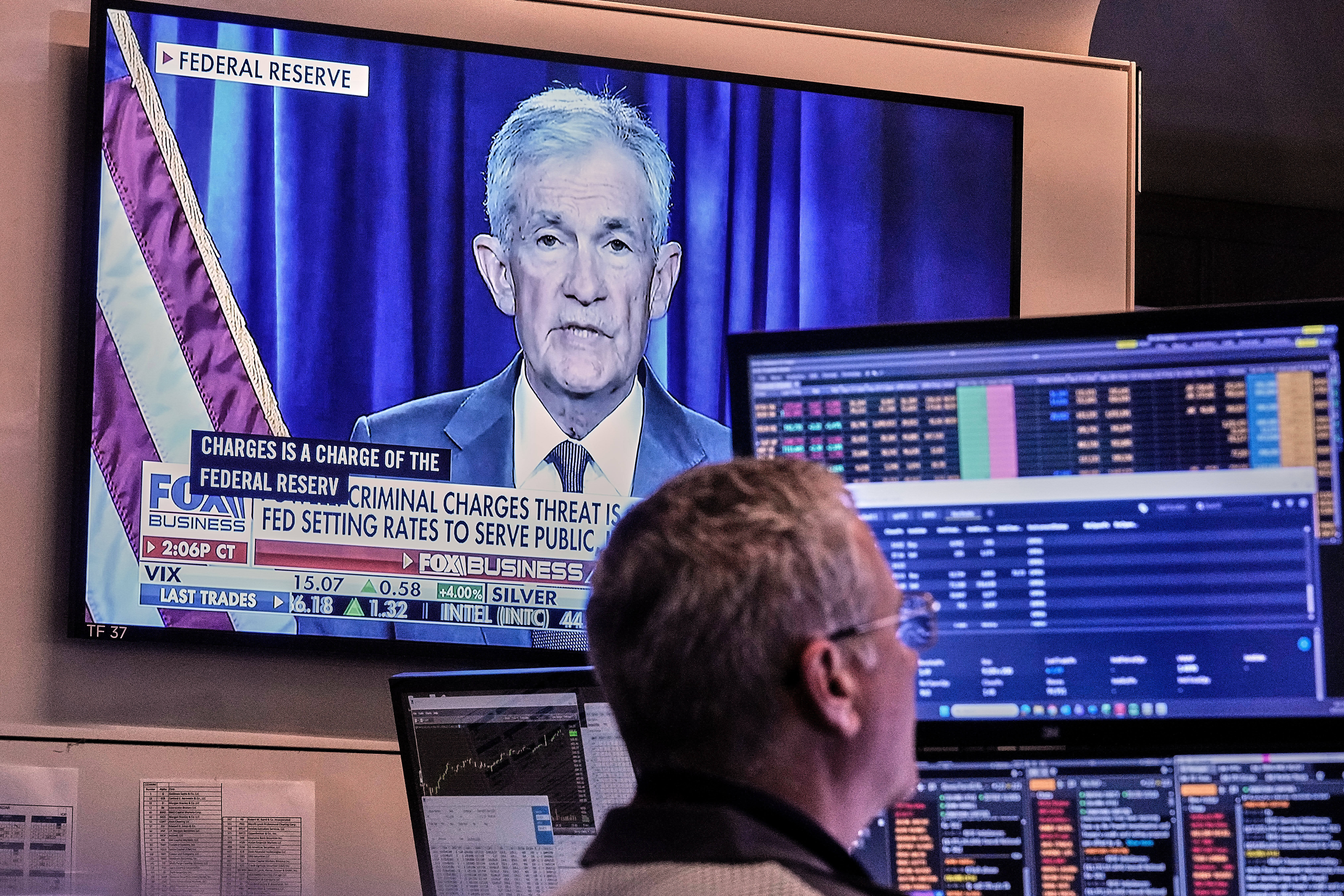 A video of Federal Reserve Chair Jerome Powell plays on a screen on the floor of the New York Stock Exchange