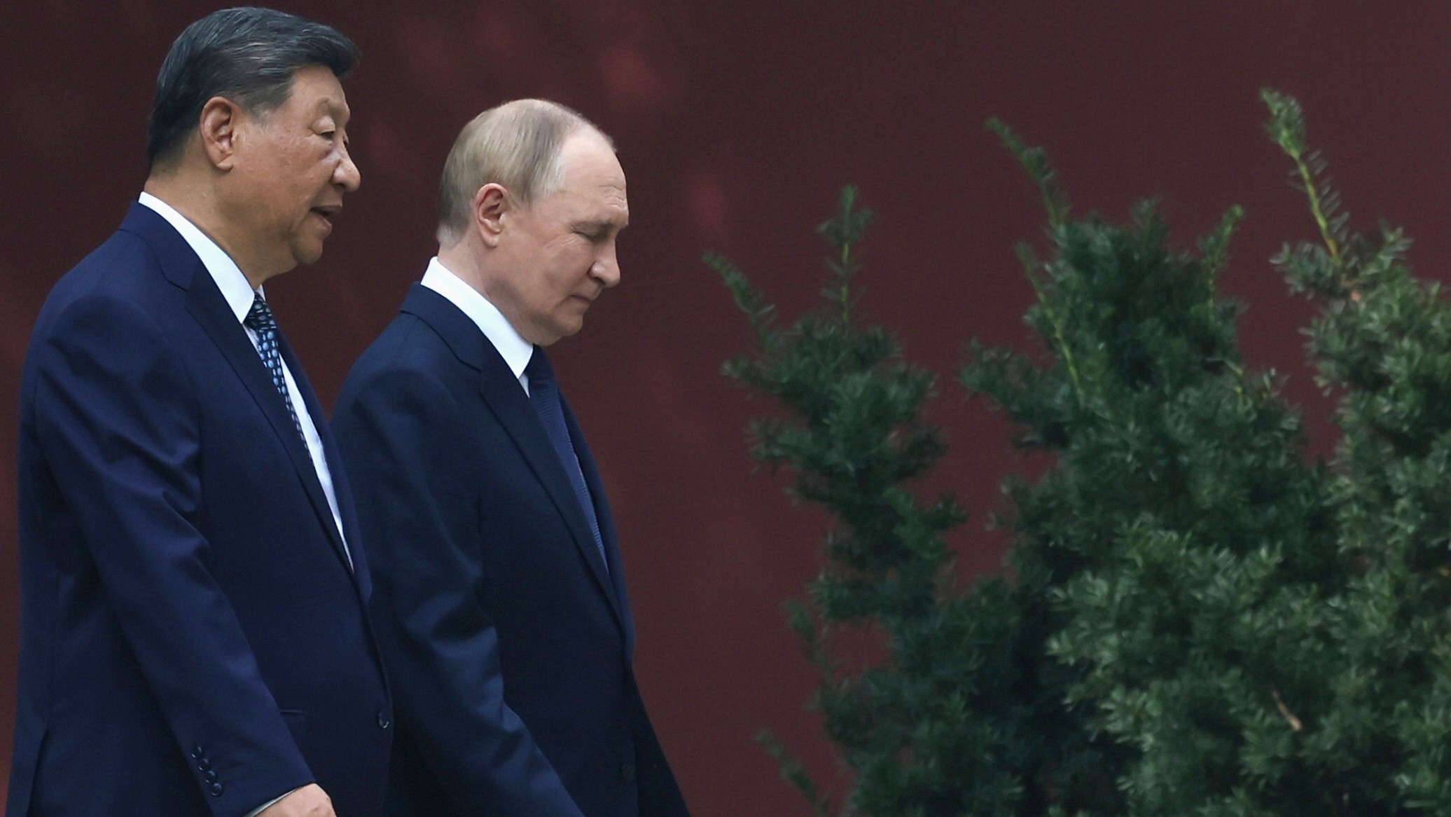 Russian President Vladimir Putin, right, speaks with Chinese President Xi Jinping during a walk at the Zhongnanhai leadership compound in Beijing, China, September 2, 2025. 