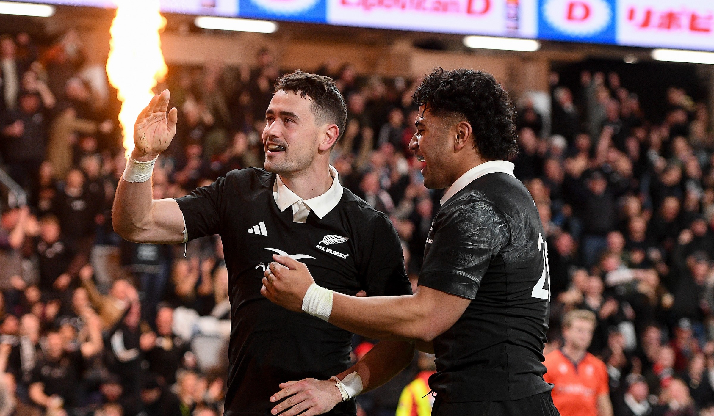 Will Jordan celebrates one of his two tries against France with loose forward Wallace Sititi.