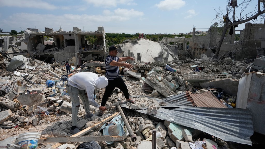 Residents search through the rubble of homes destroyed in an Israeli airstrike a day earlier in the southern village of Charnay, Lebanon, Wednesday, May 27, 2026.