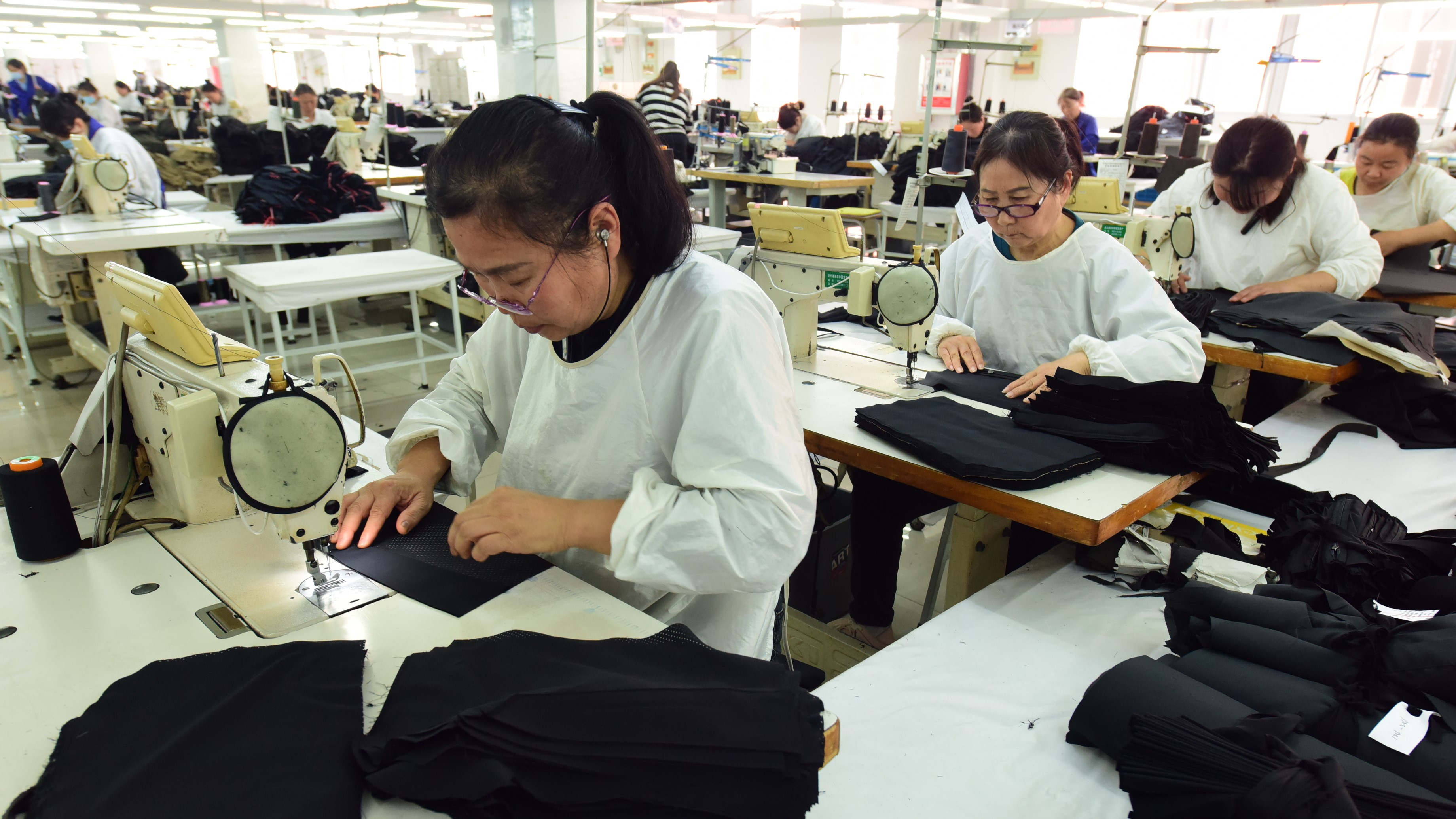 A worker produces garments for export to foreign countries at a workshop in Lianyungang, Jiangsu province, China, on April 8, 2025. 