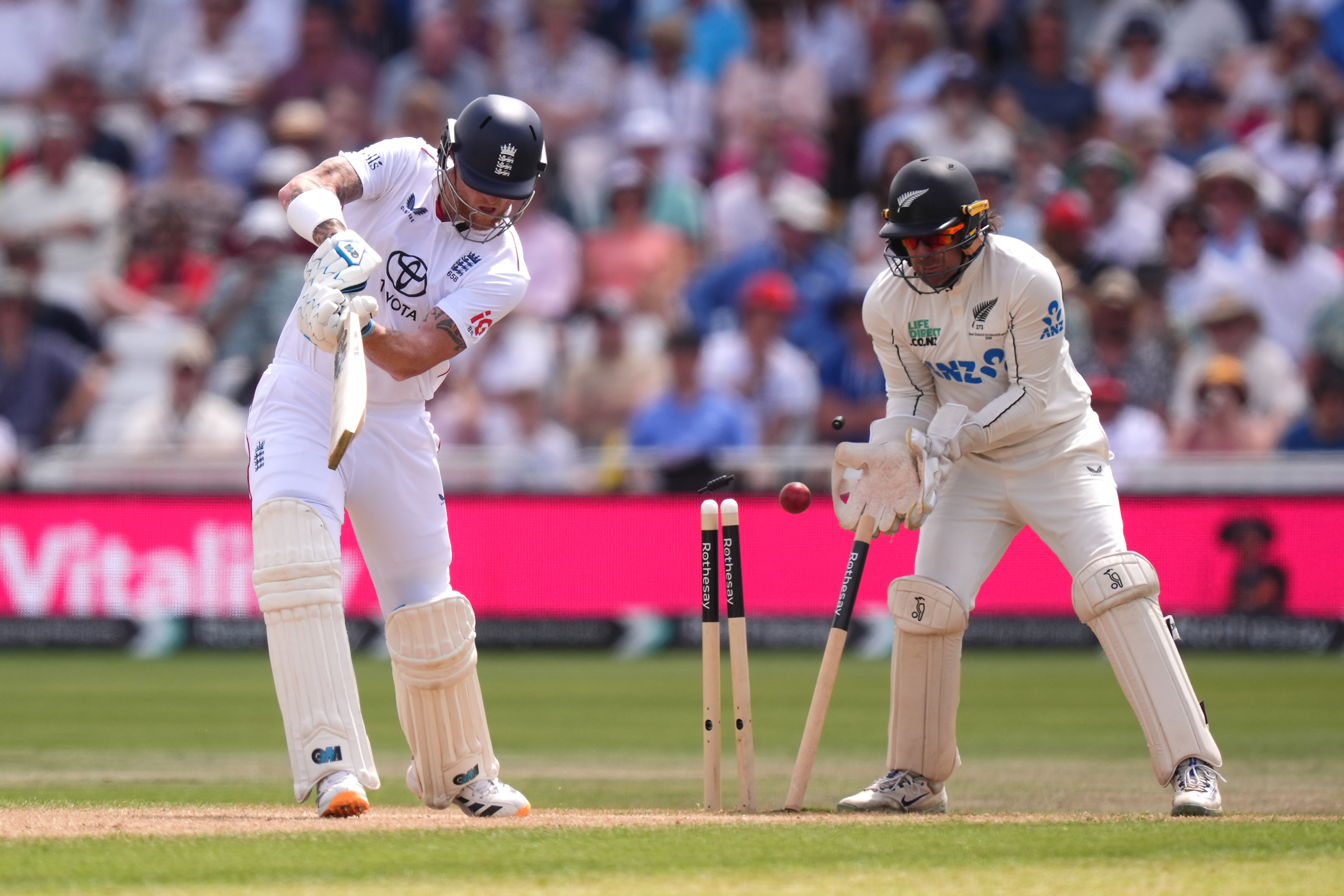 England's Ben Stokes, left, is bowled out by New Zealand's Zak Foulkes, during day three of the Third Test cricket match between England and New Zealand.