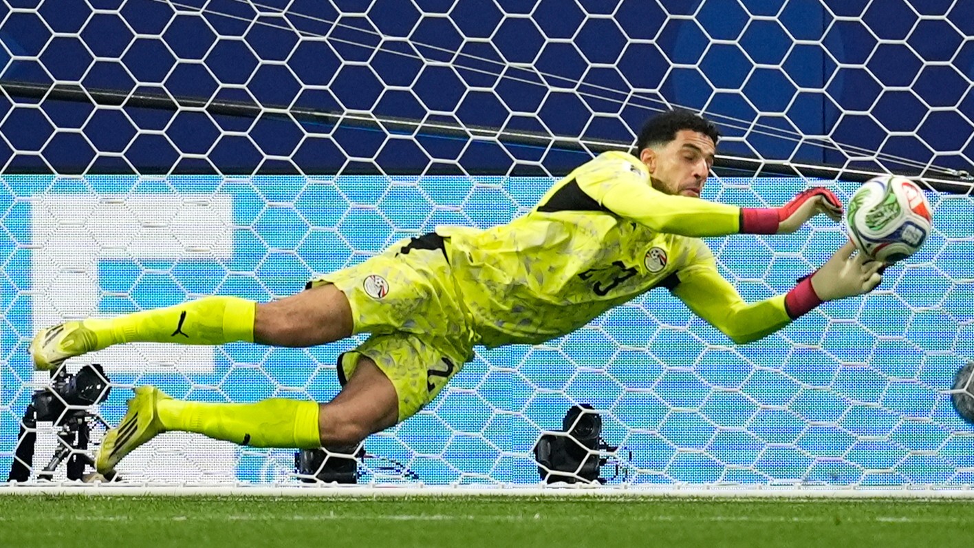 Egypt goalkeeper Mostafa Shoubir (23) saves a penalty kick from Argentina's Lionel Messi (10) during the World Cup round of 16 soccer match between Argentina and Egypt in Atlanta.