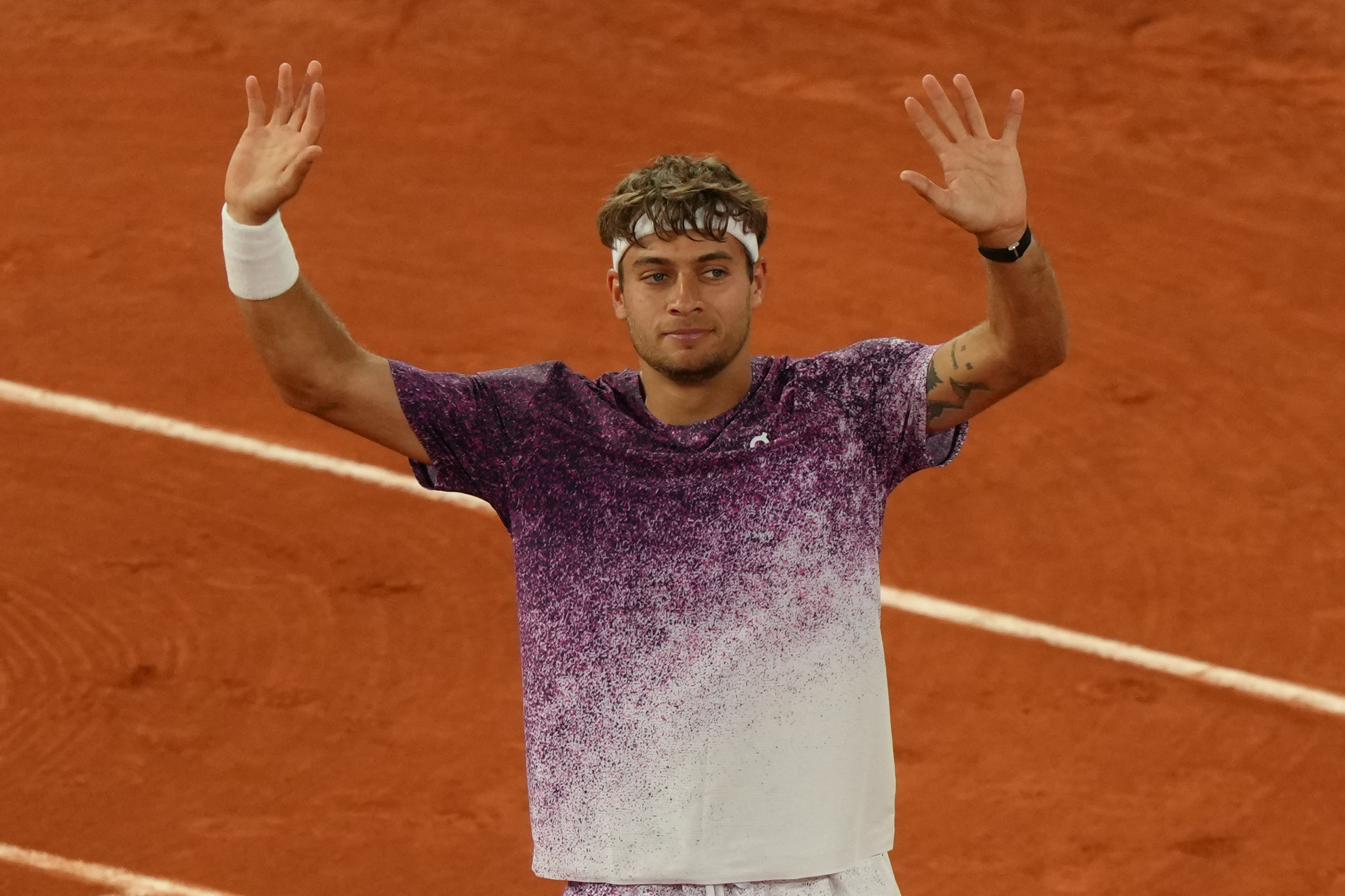Italy's Flavio Cobolli reacts after winning the quarterfinal tennis match against Canada's Felix Auger-Aliassime at the French Open in Paris