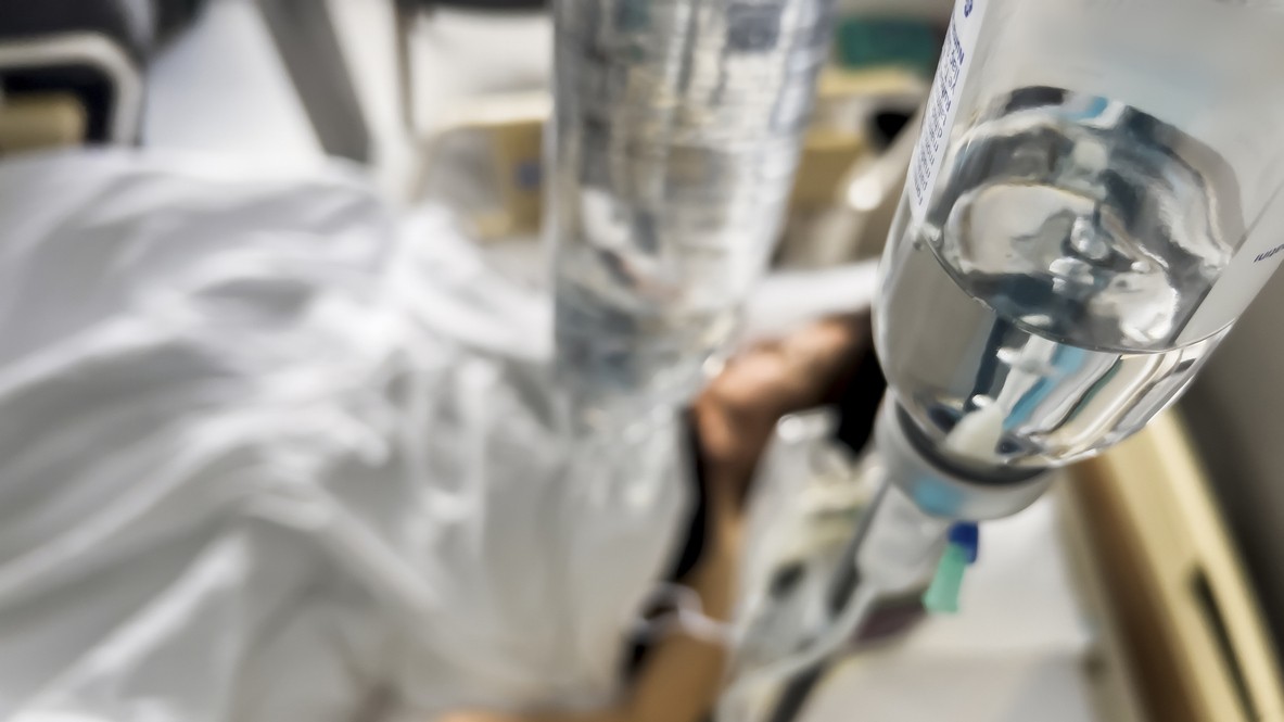 Person on an IV drip being cared for in hospital.