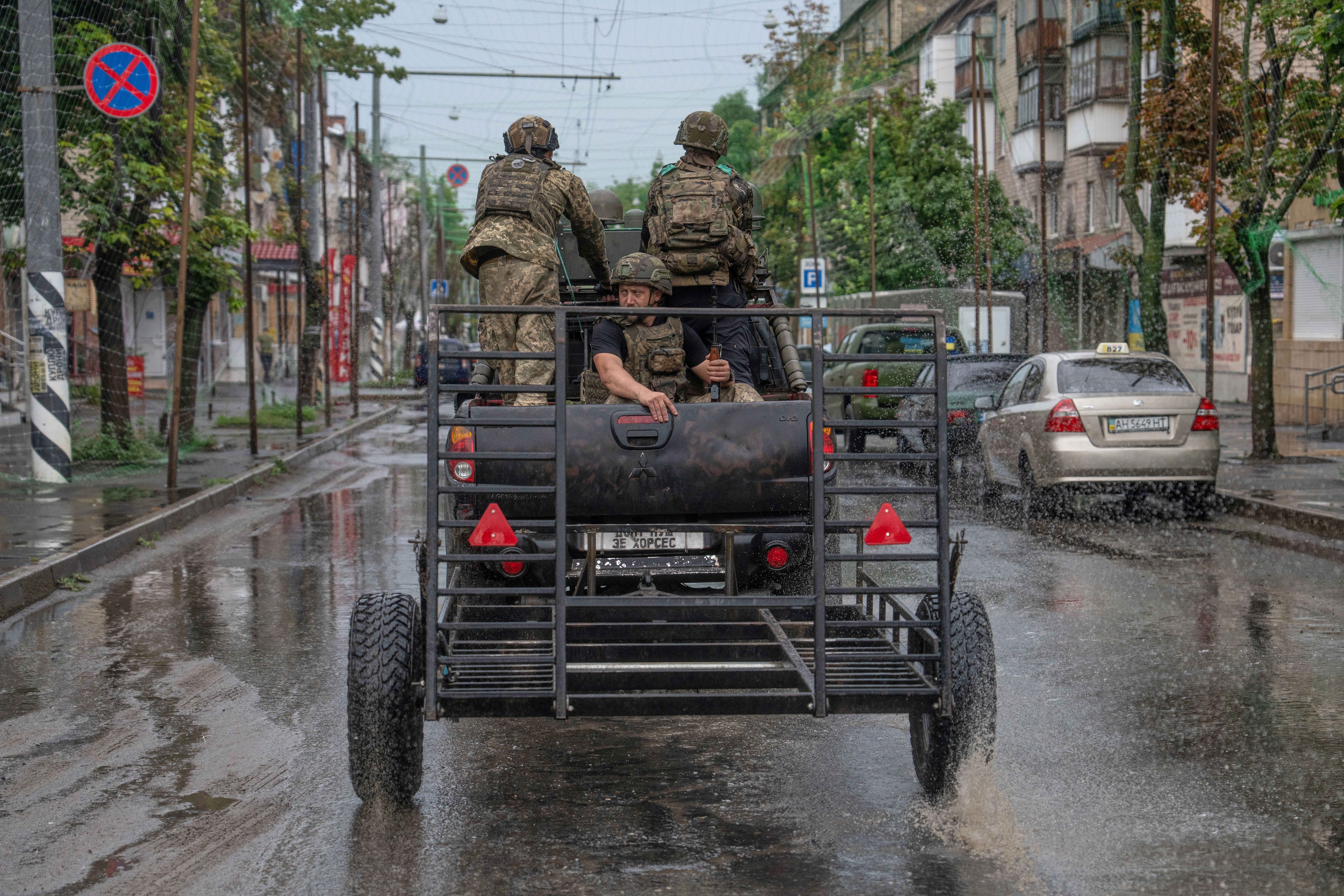 In this photo provided by Ukraine's 93rd Kholodnyi Yar Separate Mechanized Brigade press service, Ukrainian servicemen patrol a street in the frontline town of Druzhkivka, Donetsk region.