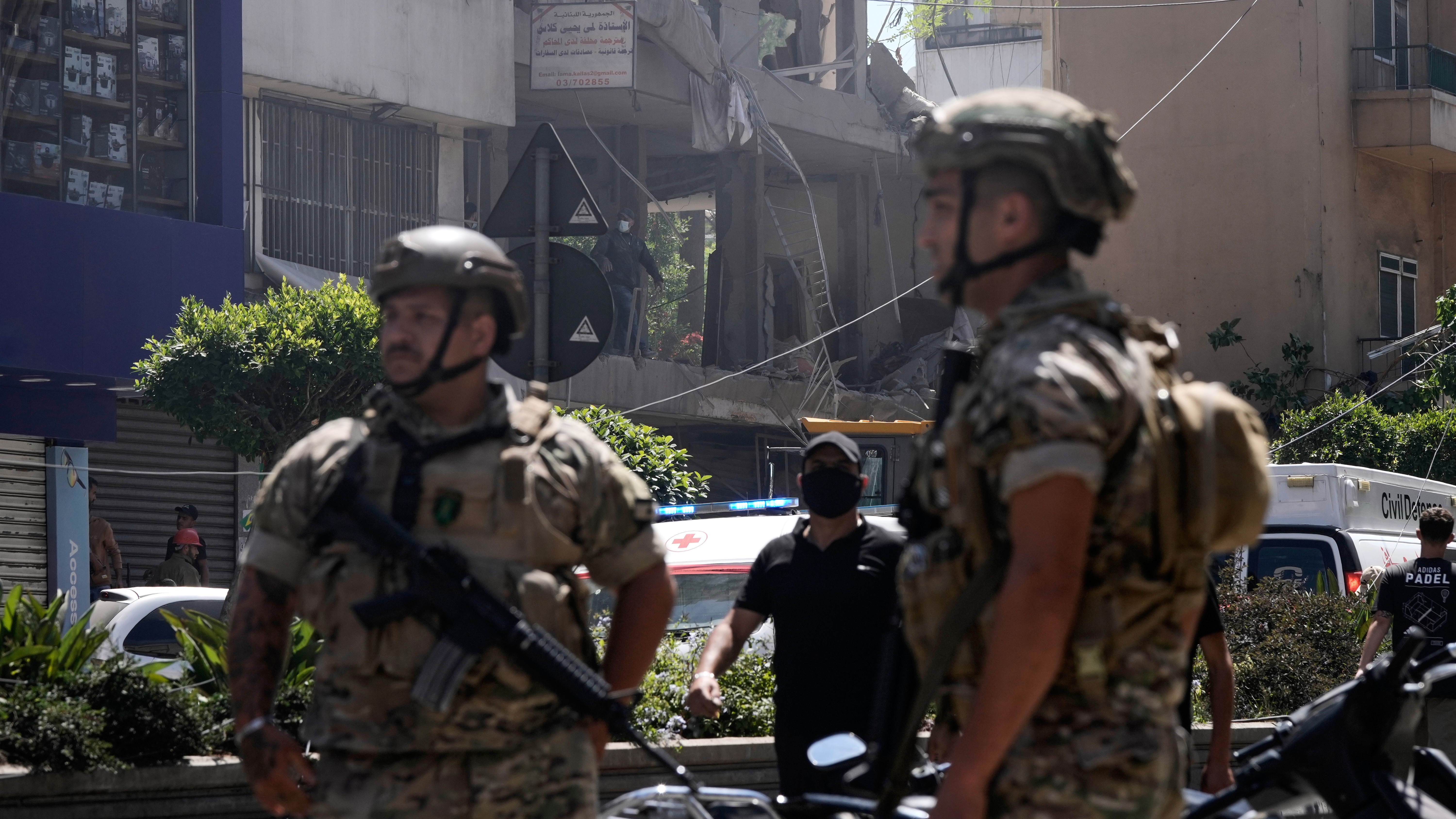 Lebanese soldiers stand guard at the site of an Israeli airstrike that struck an apartment in Dahiyeh, Beirut's southern suburbs, Lebanon.