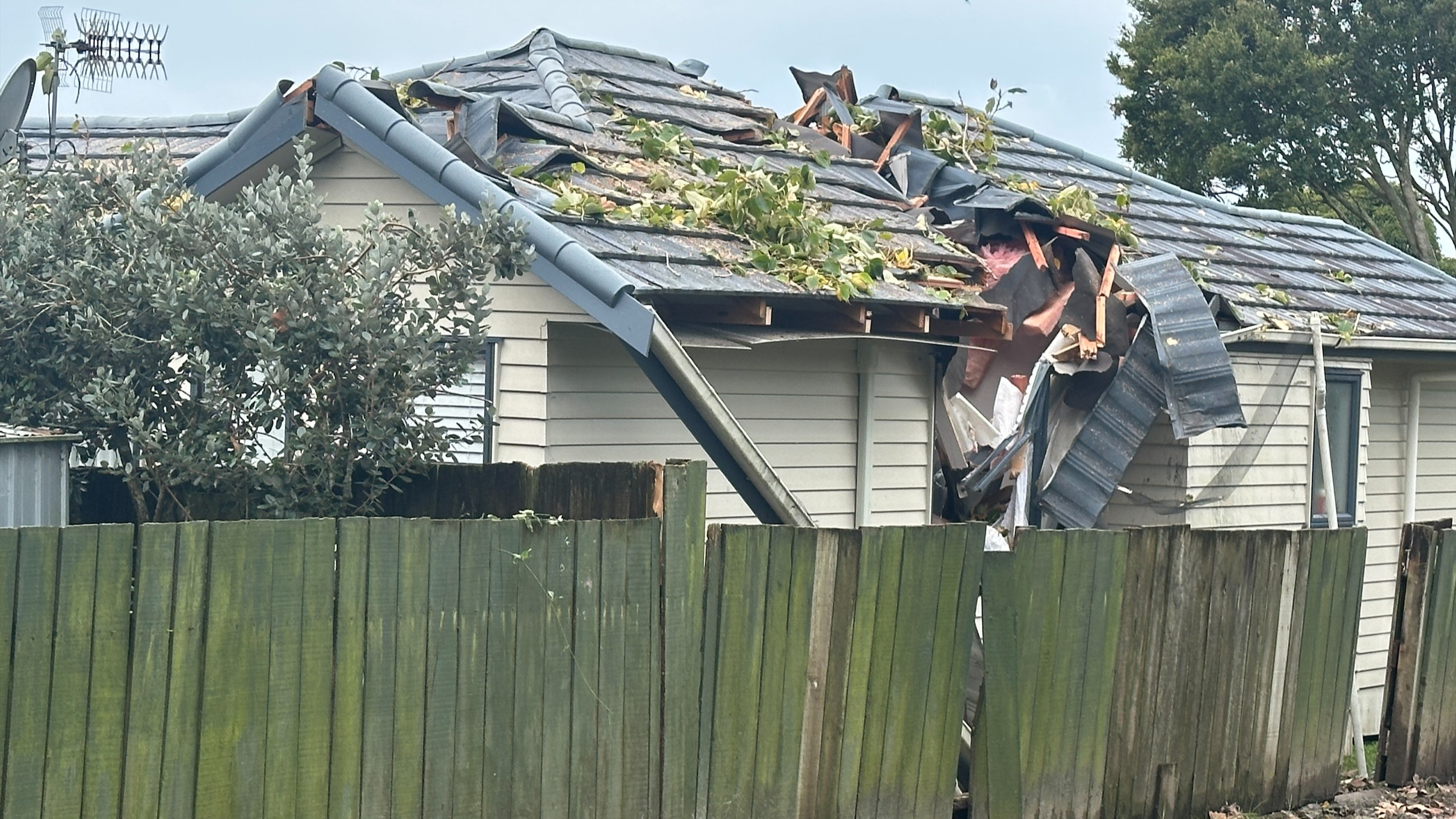Damage after a tree fell on a home in Rānui last night.