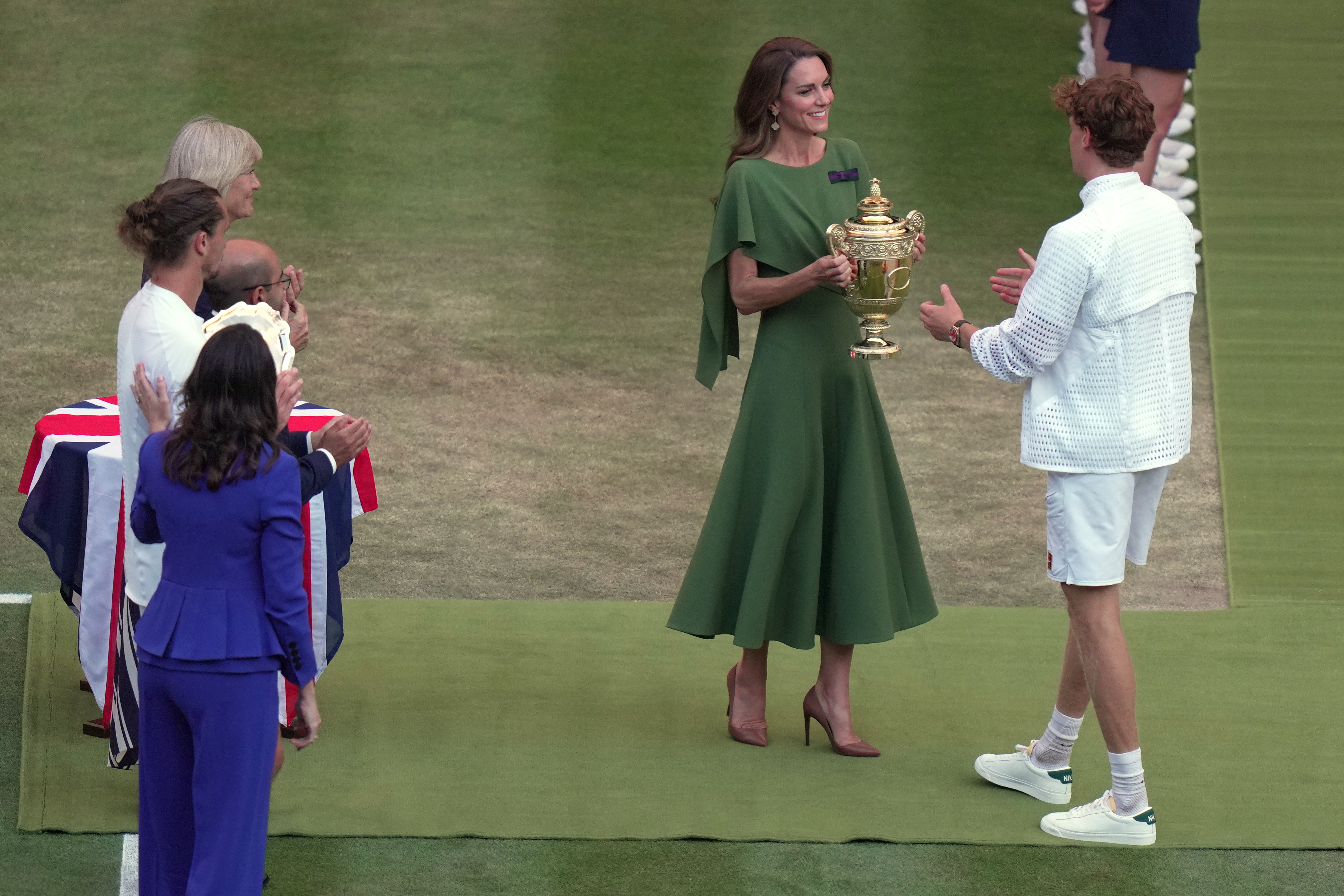 Britain's Princess Kate presents the champion trophy to Jannik Sinner of Italy after winning against Alexander Zverev of Germany in the men's singles final at Wimbledon Tennis Championships