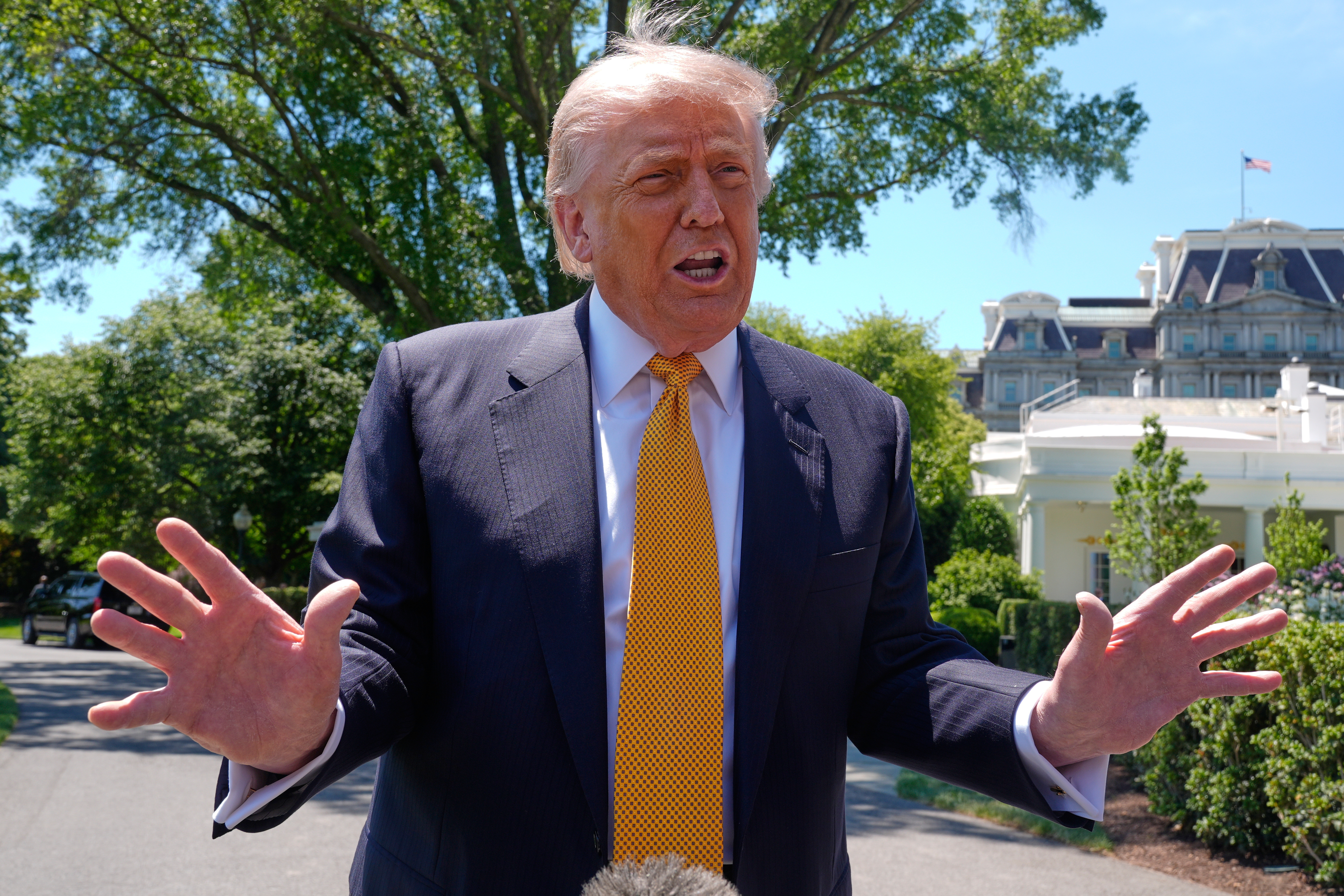 President Donald Trump speaks to reporters as he leaves the White House for travel to Beijing, Wednesday, May 13, 2026, in Washington, to meet with China's President Xi Jinping. 