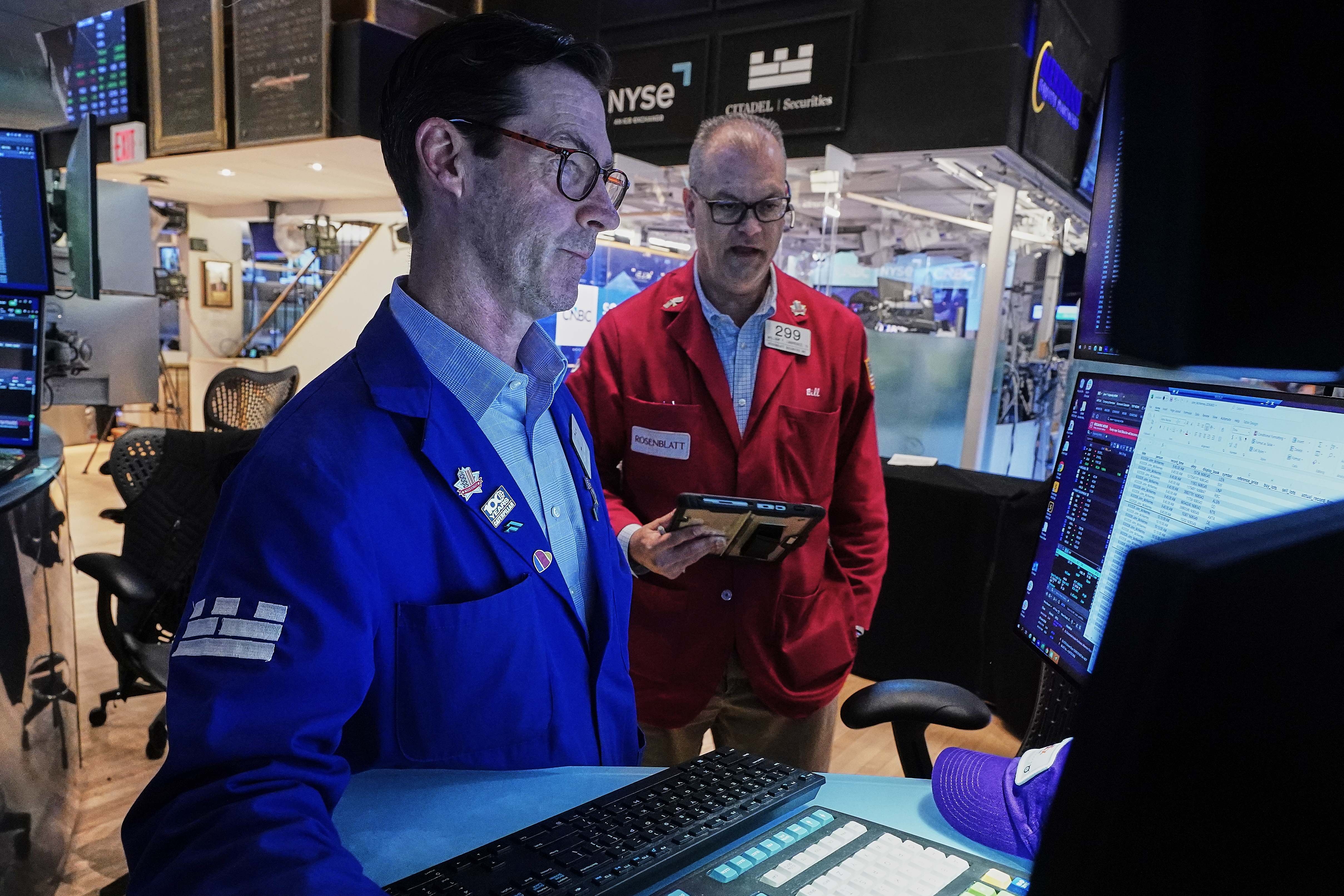 Specialist John McNierney, left, and trader William Lawrence work on the floor of the New York Stock Exchange, Wednesday, June 3, 2026. 
