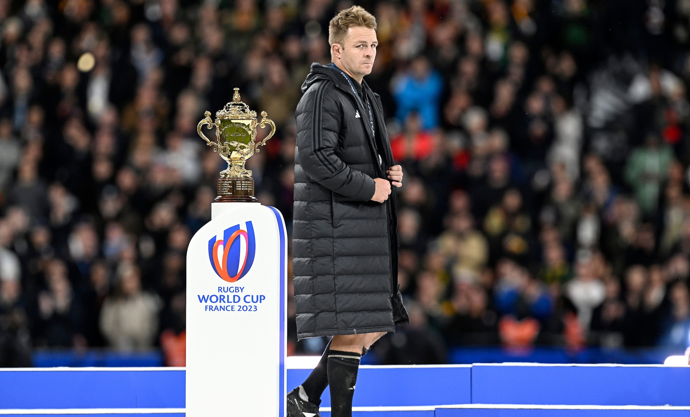 A crestfallen Sam Cane walks past the William Webb Ellis Cup after his side lost the final to South Africa.